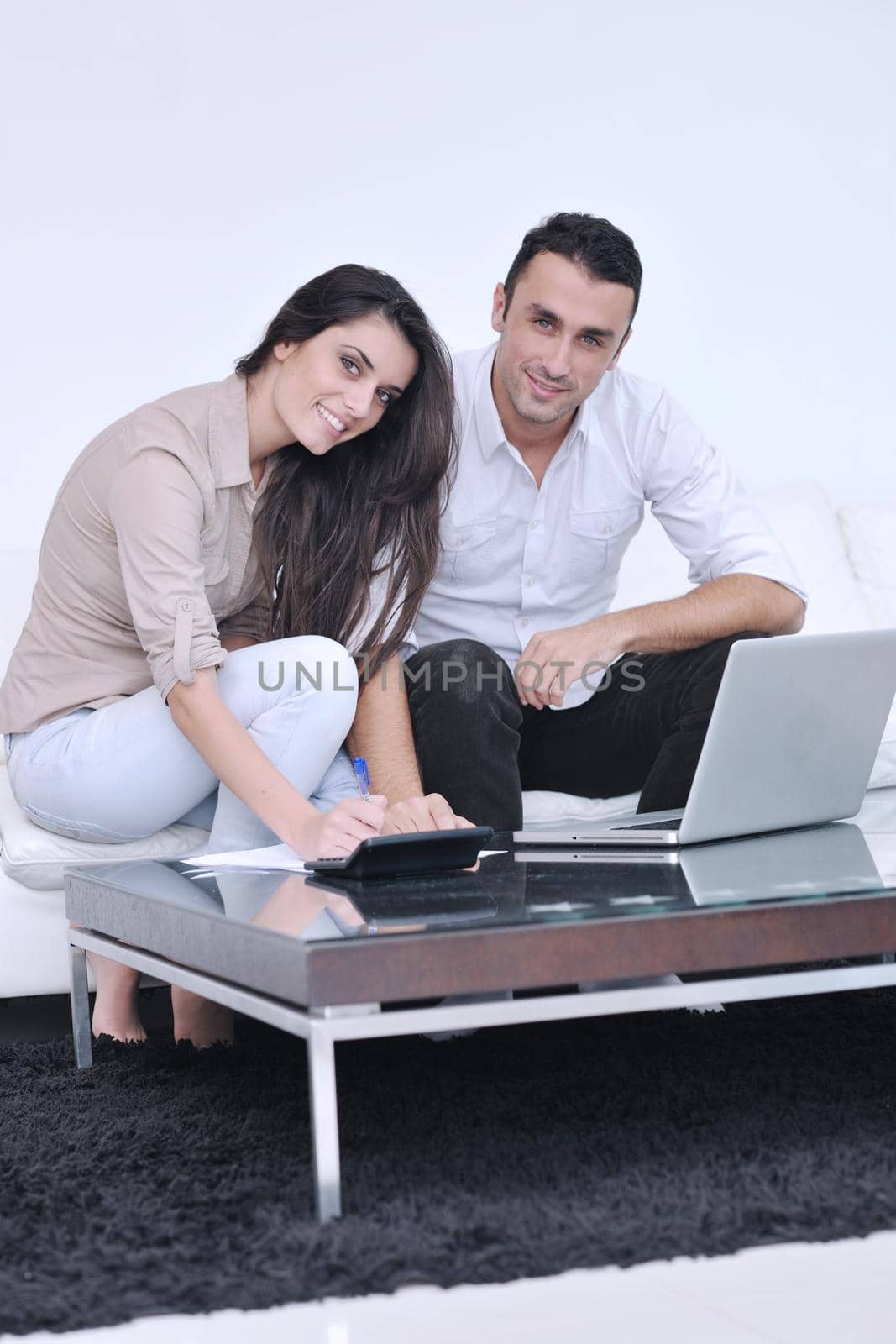 joyful couple relax and work on laptop computer at modern home by dotshock