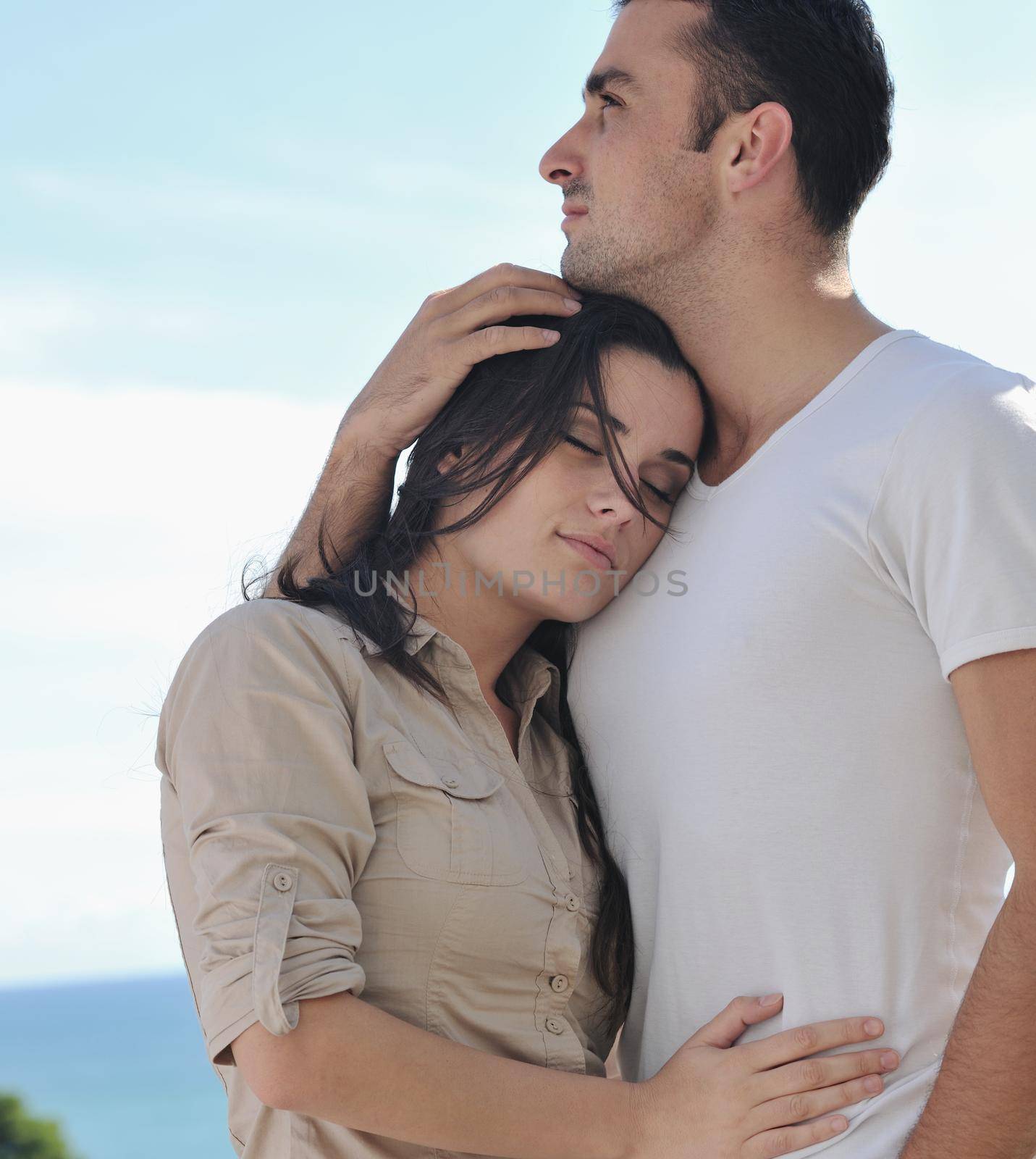 happy young couple in love have romance  relax on balcony outdoor with ocean and blue sky in background