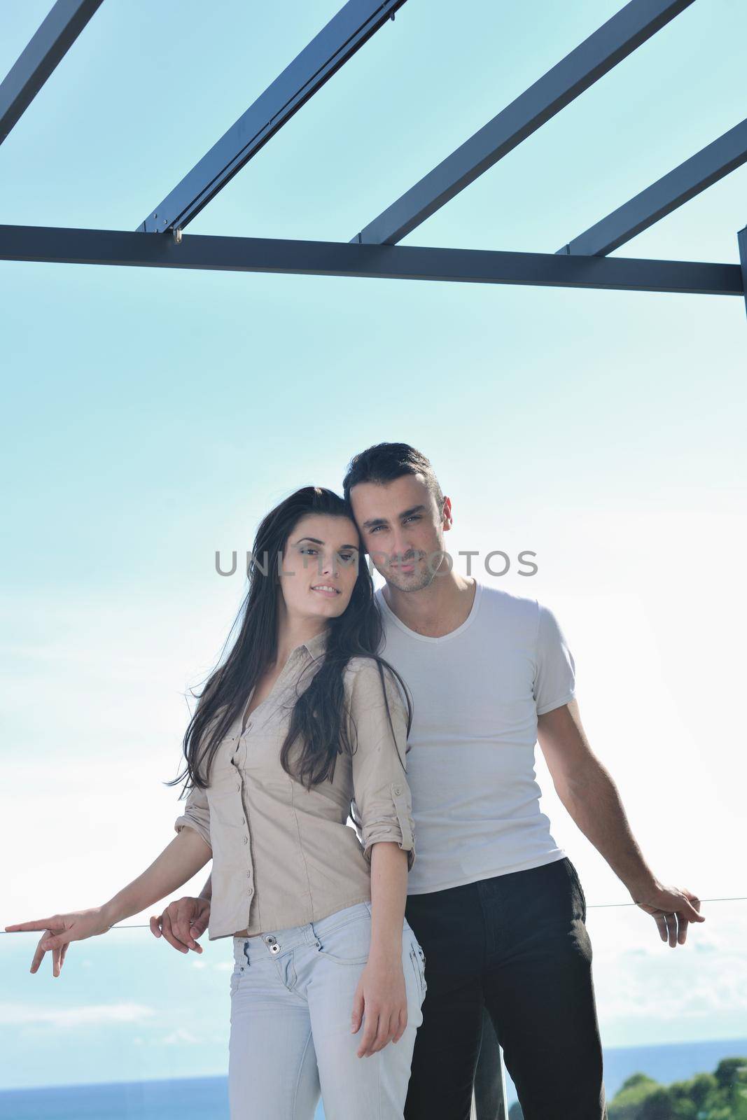 happy young couple in love have romance  relax on balcony outdoor with ocean and blue sky in background