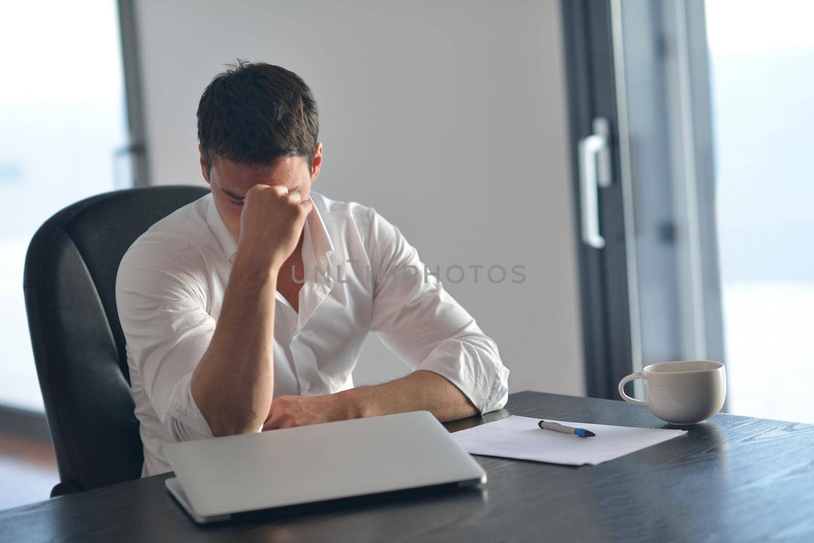 frustrated with problems young business man working on laptop computer at home