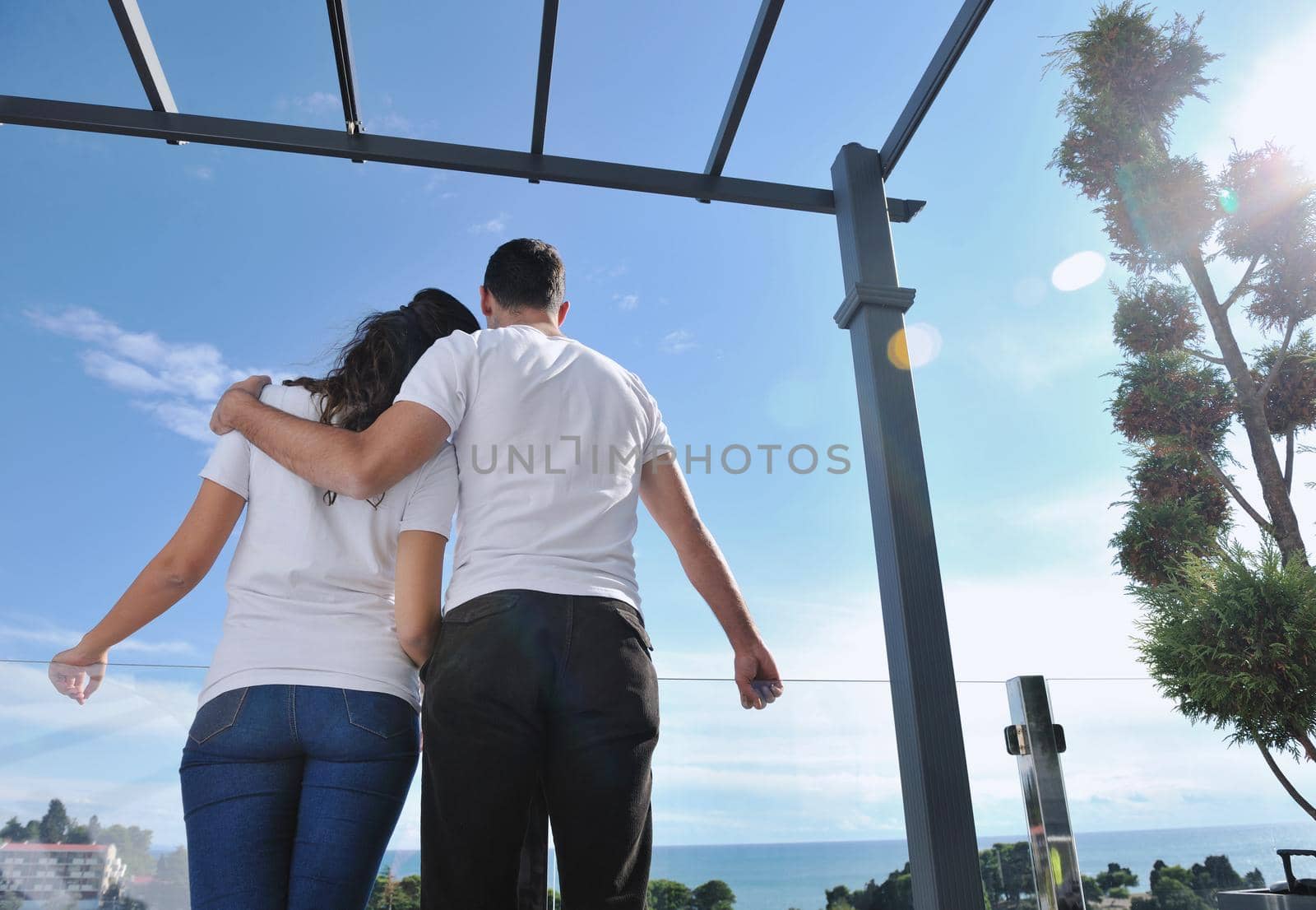 couple relaxing on balcony by dotshock