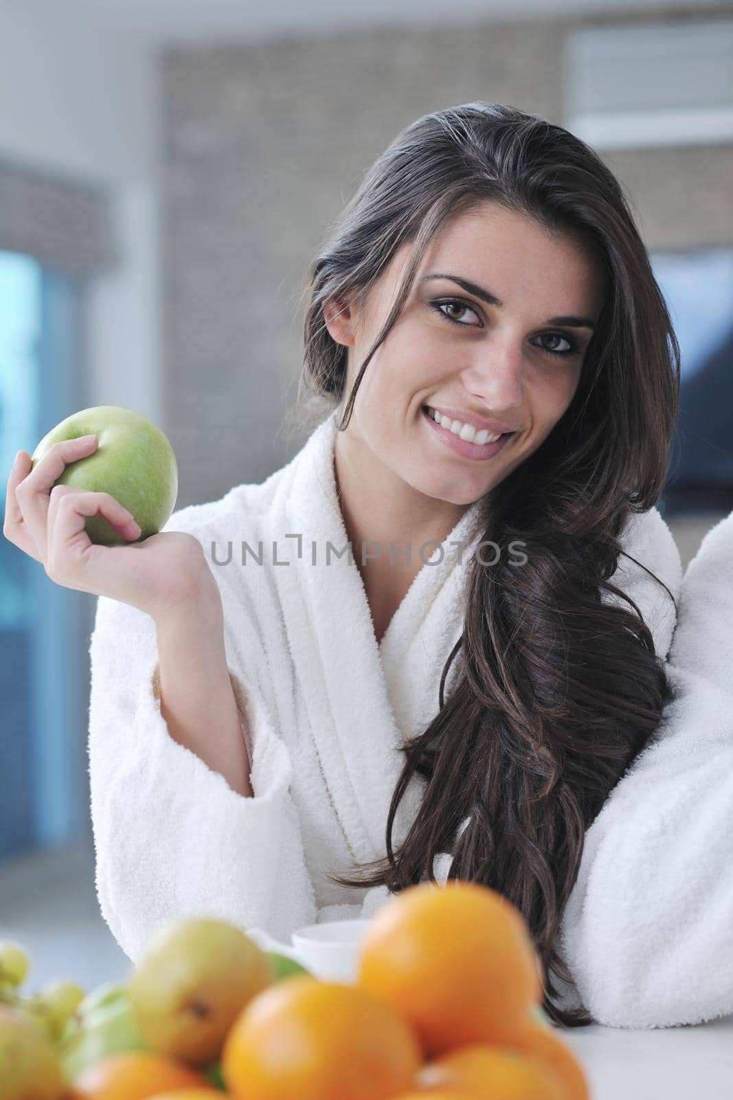 happy young couple have fun in  modern kitchen indoor  while preparing fresh fruits and vegetables food salad