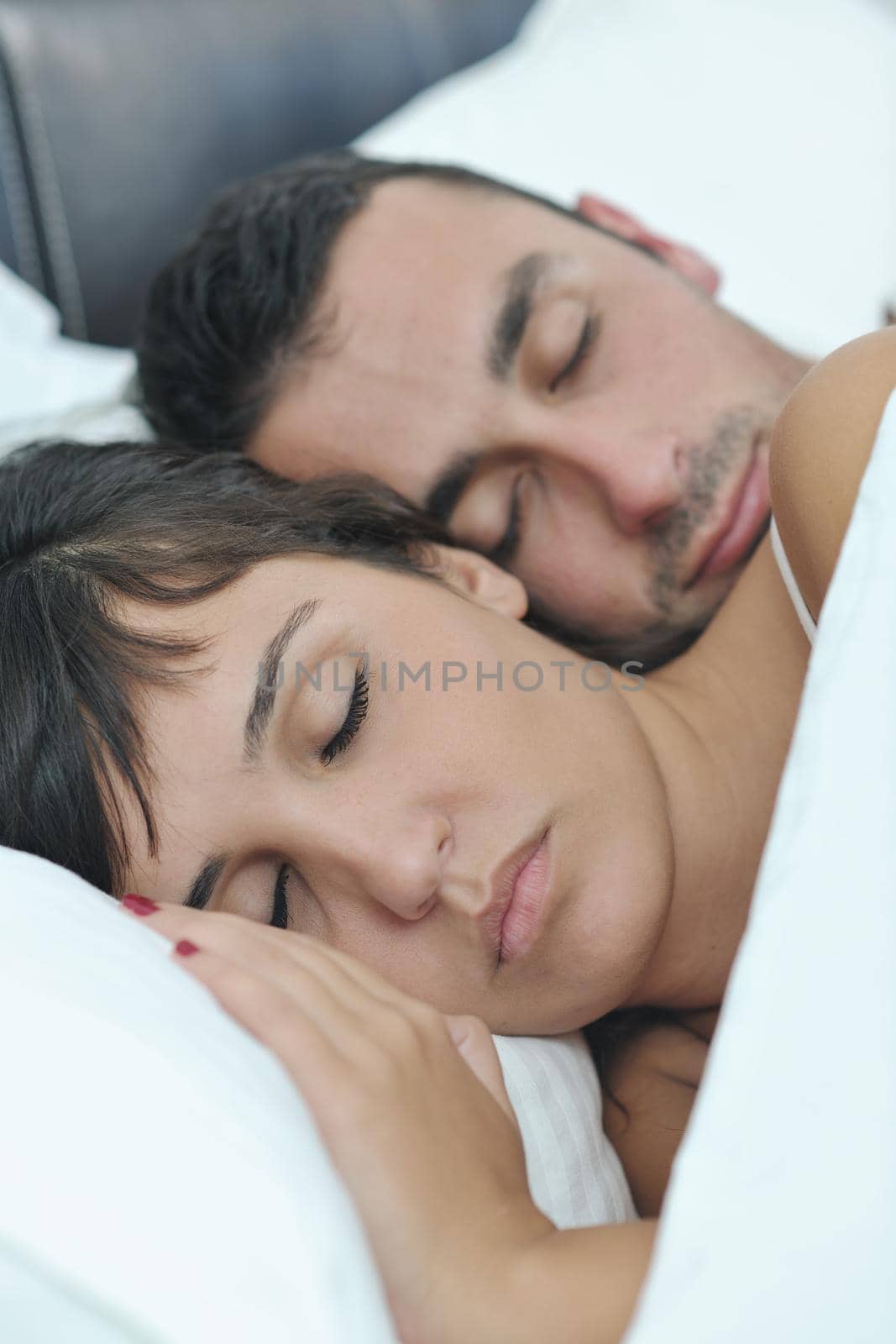 happy young healthy people  couple have good time in their bedroom make love and sleep