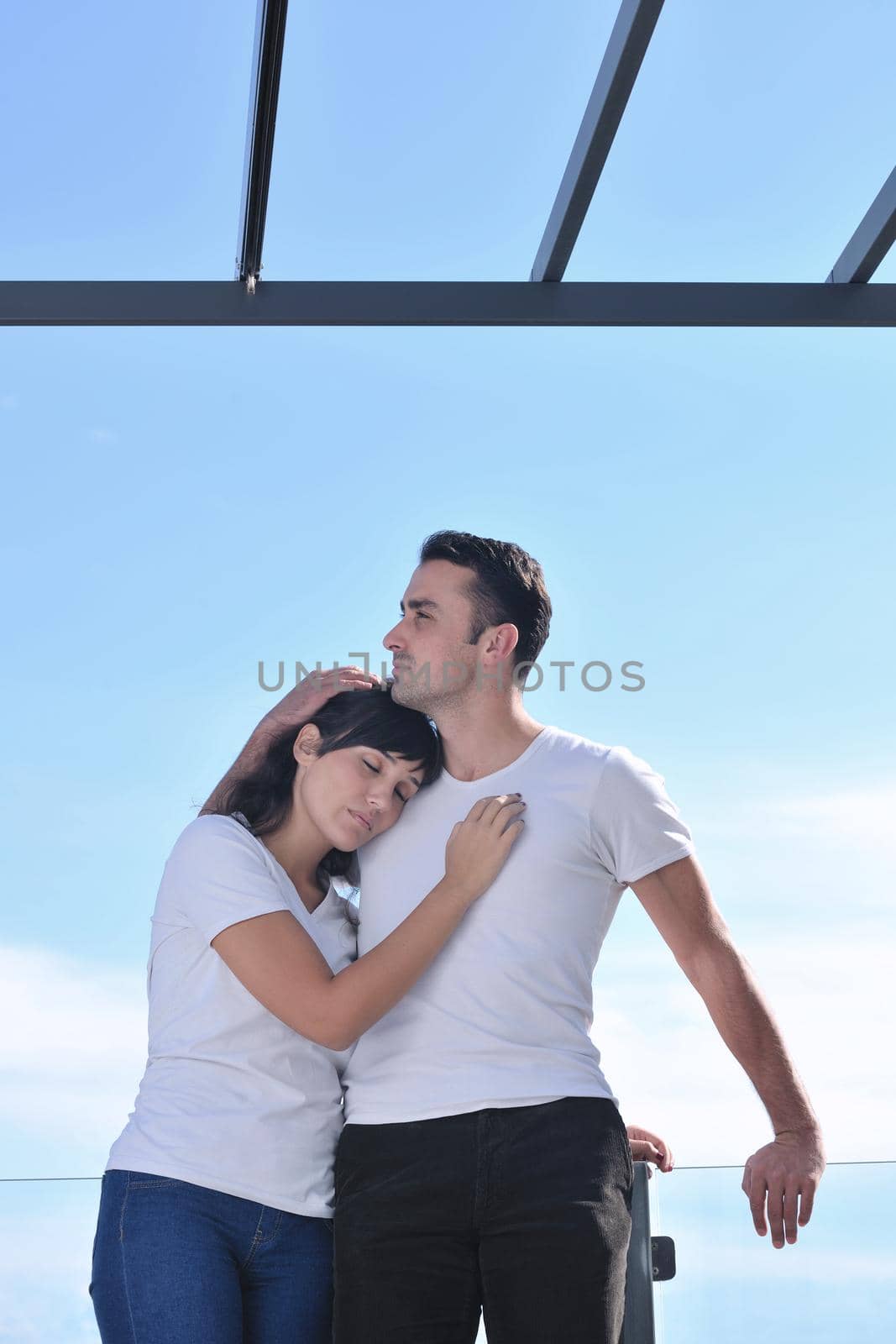 couple relaxing on balcony by dotshock