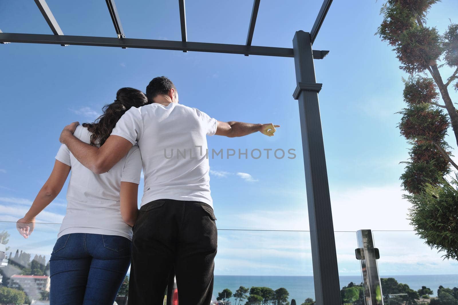 happy young couple in love have romance  relax on balcony outdoor with ocean and blue sky in background