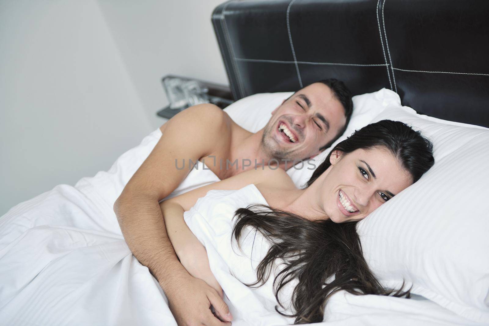 happy young healthy people  couple have good time in their bedroom make love and sleep