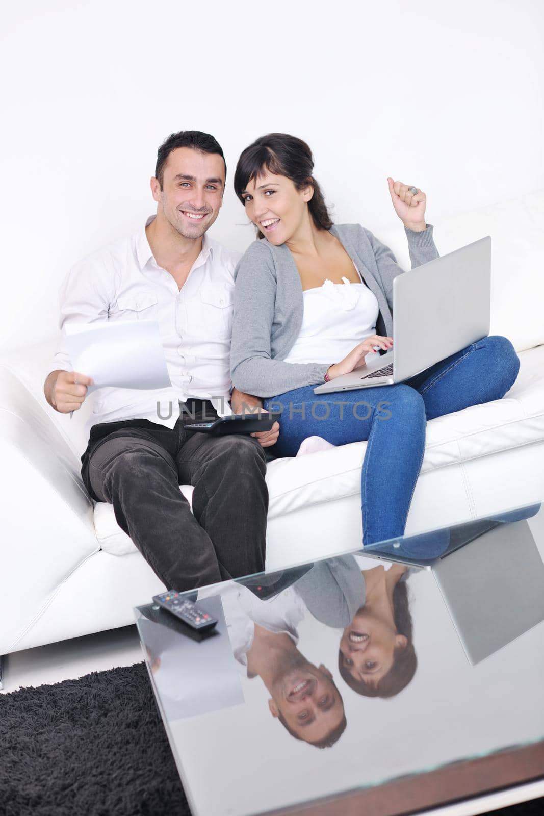 joyful couple relax and work on laptop computer at modern living room indoor home