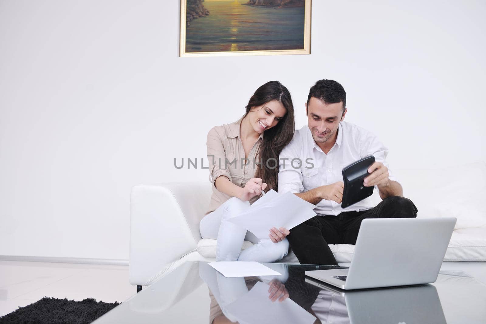 joyful couple relax and work on laptop computer at modern living room indoor home