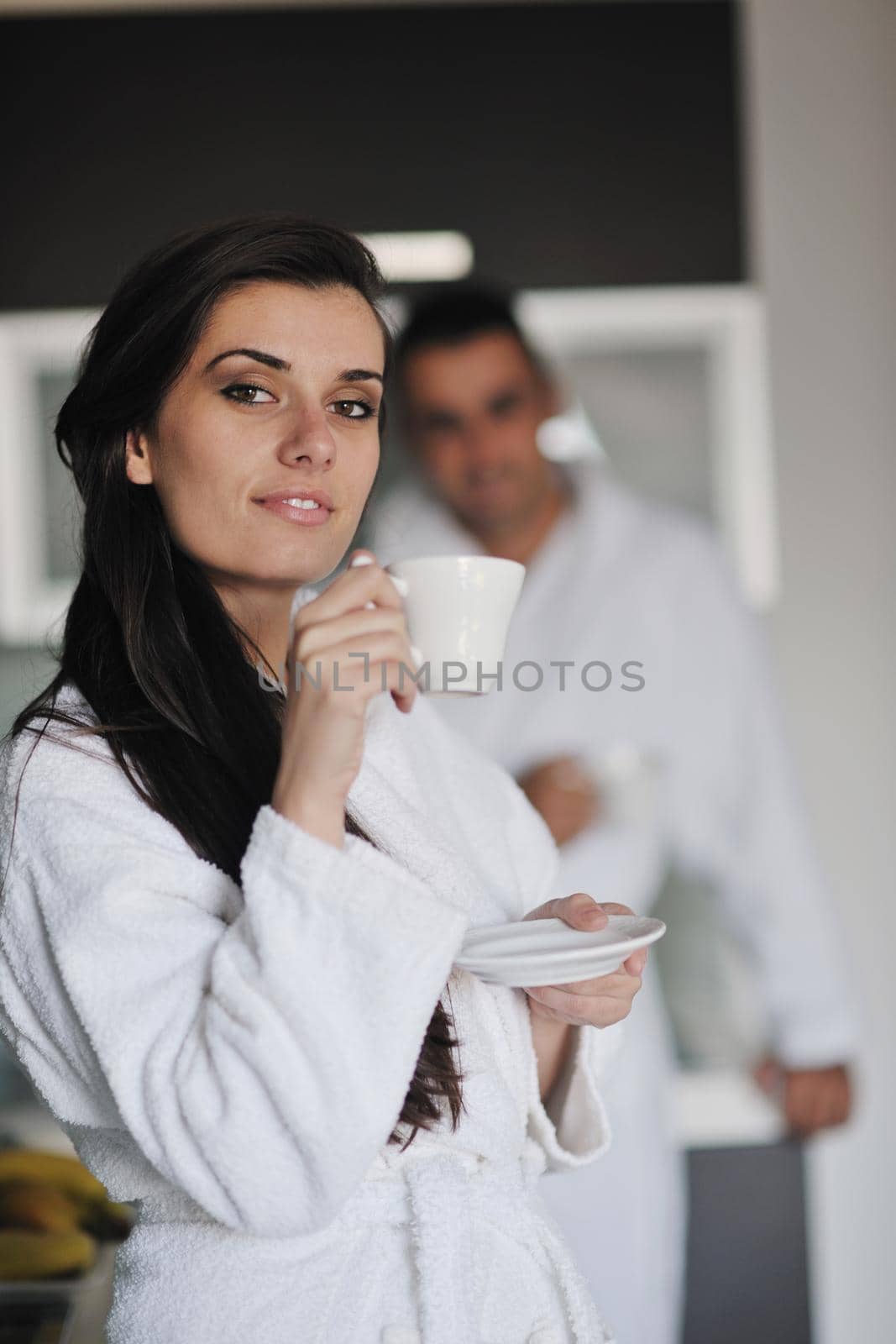 Young love couple taking fresh morning cup of coffee by dotshock