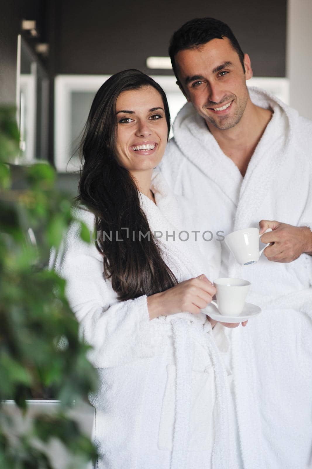Young love couple taking fresh morning cup of coffee by dotshock