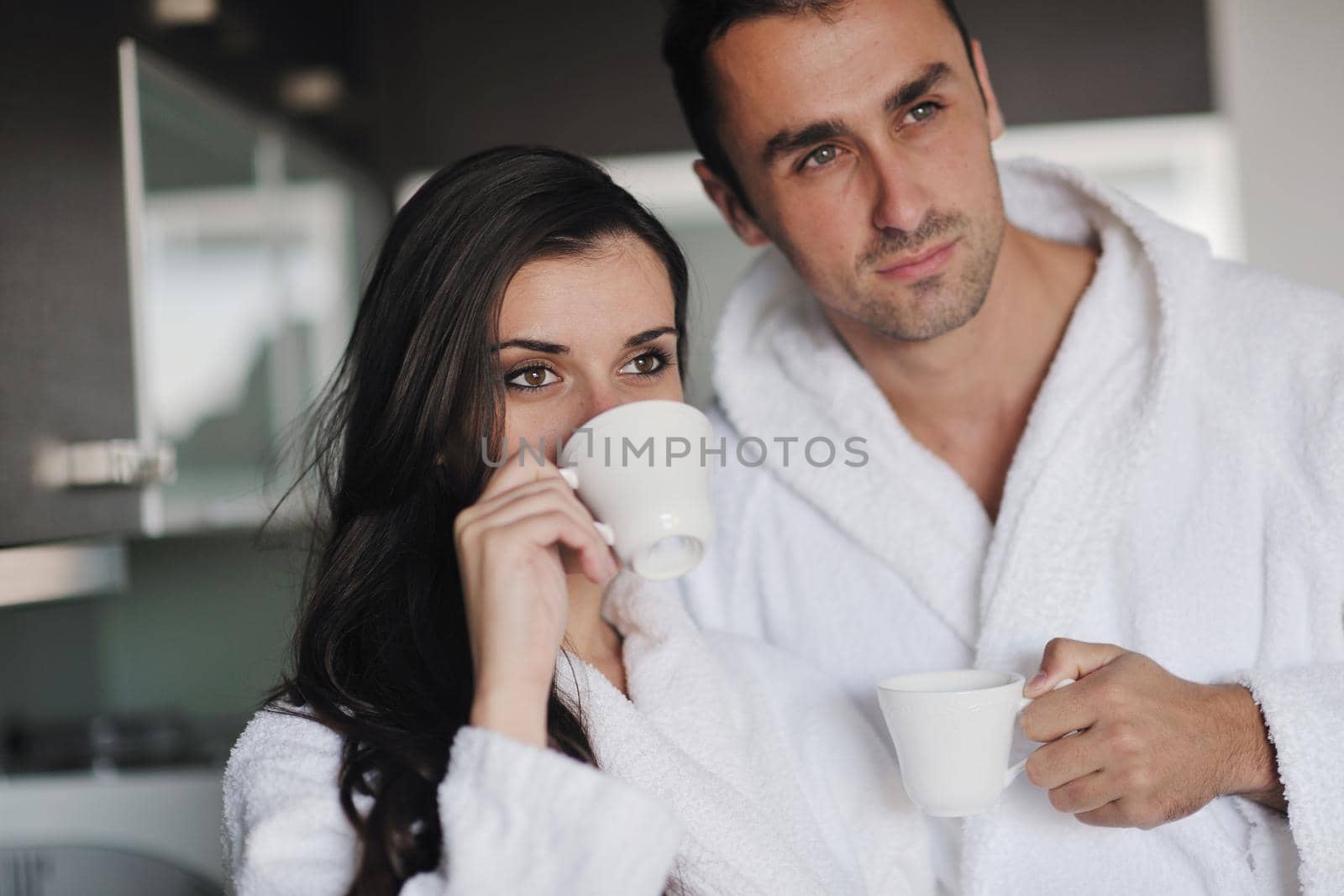 Young love couple taking fresh morning cup of coffee by dotshock