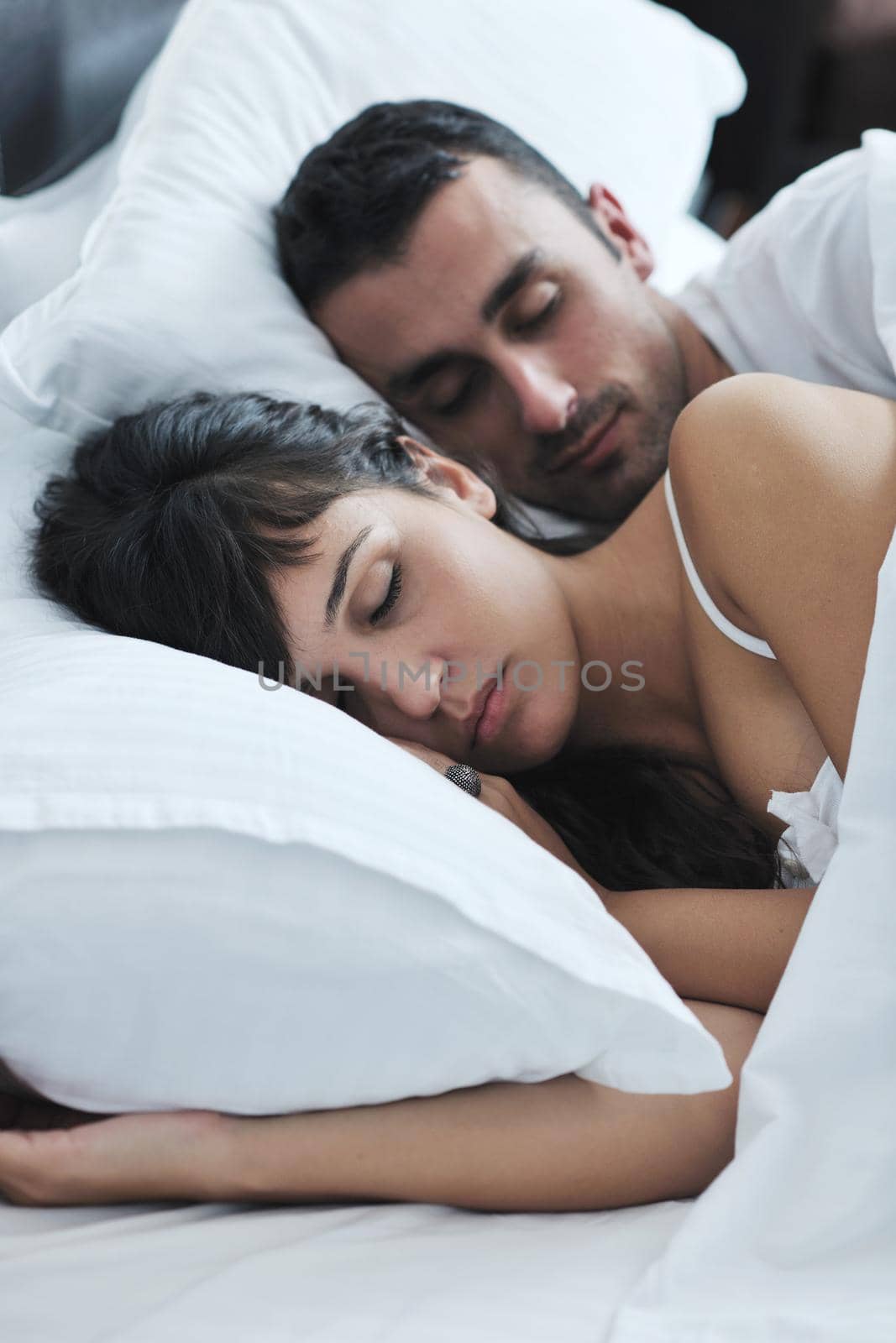 happy young healthy people  couple have good time in their bedroom make love and sleep