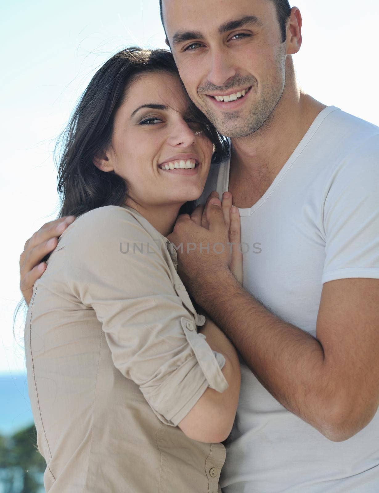 happy young couple in love have romance  relax on balcony outdoor with ocean and blue sky in background