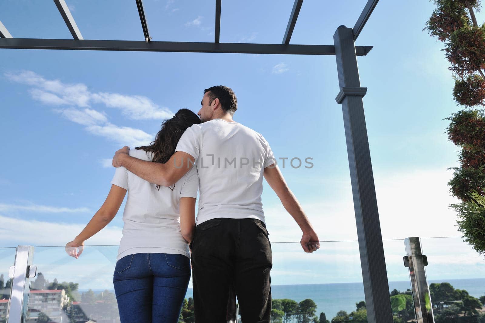 couple relaxing on balcony by dotshock