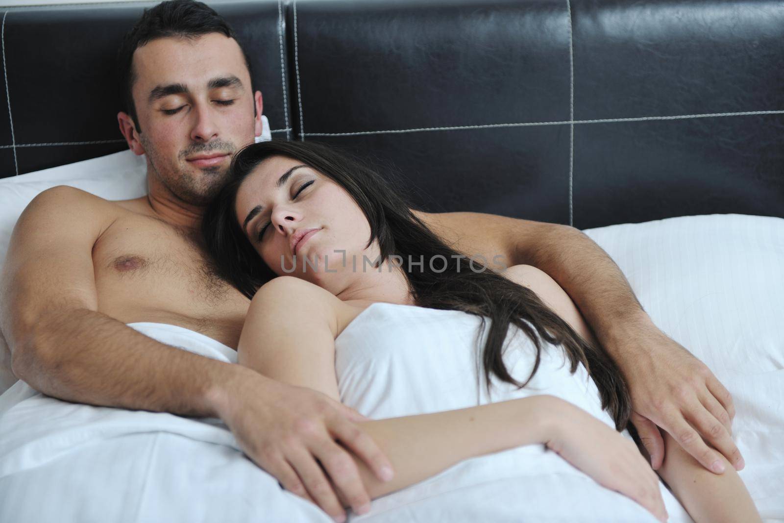 happy young healthy people  couple have good time in their bedroom make love and sleep