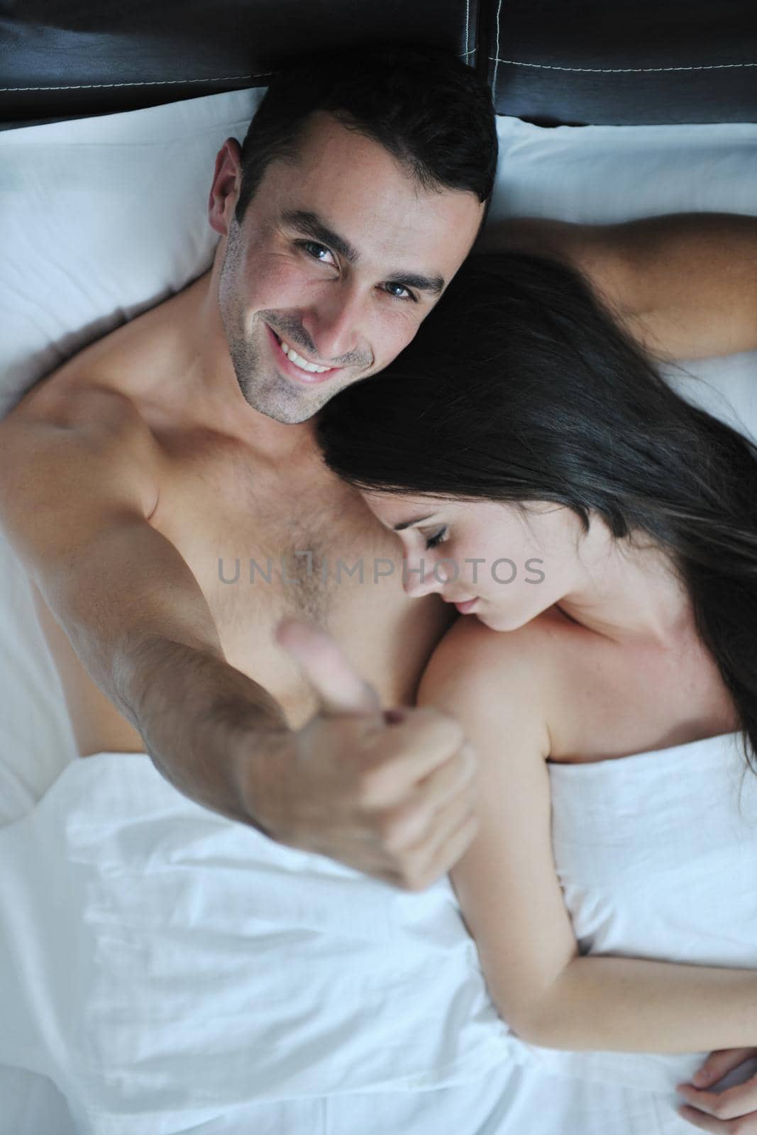 happy young healthy people  couple have good time in their bedroom make love and sleep