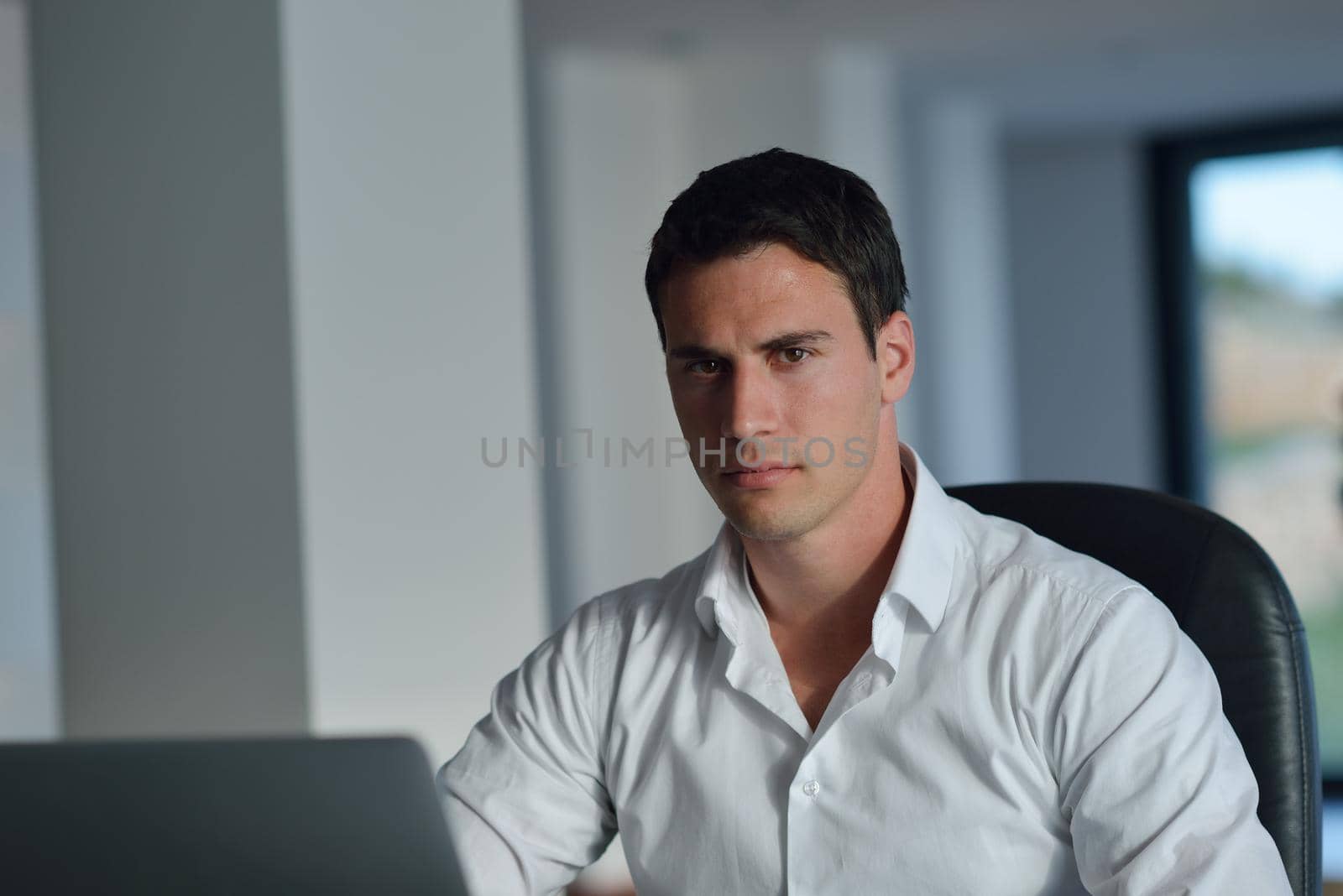 business man working on laptop computer at home by dotshock