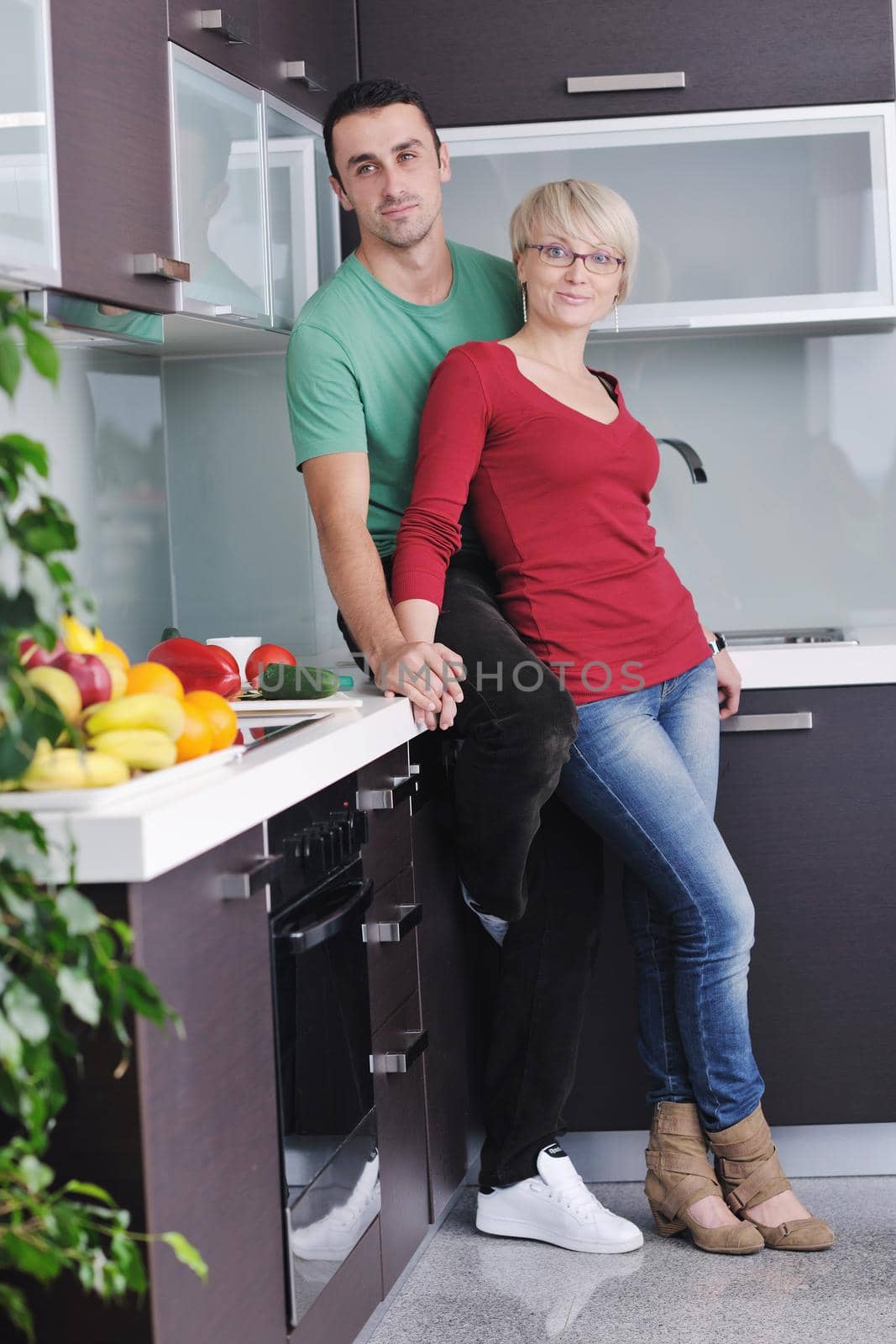 young couple have fun in modern kitchen by dotshock