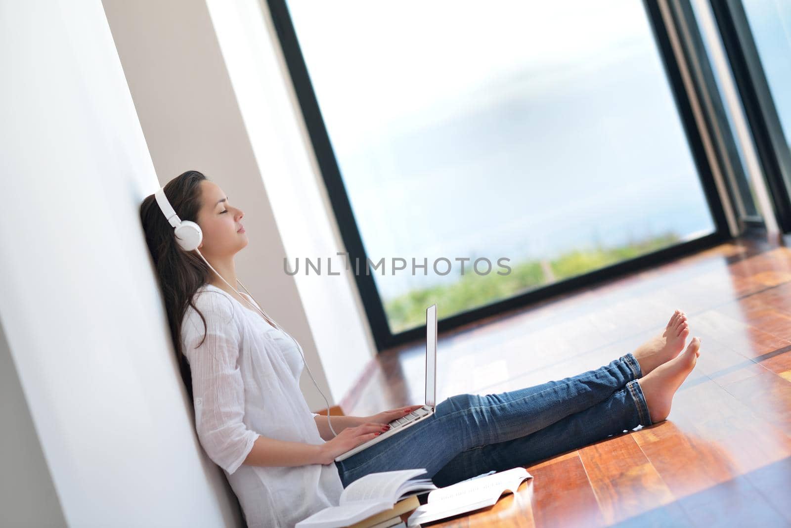 relaxed young woman at home by dotshock