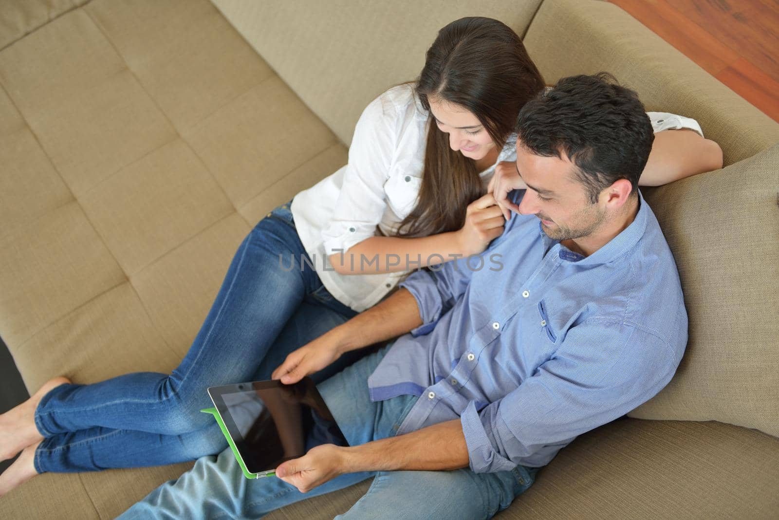 couple at home using tablet computer by dotshock