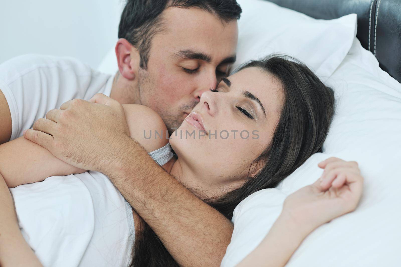 happy young healthy people  couple have good time in their bedroom make love and sleep