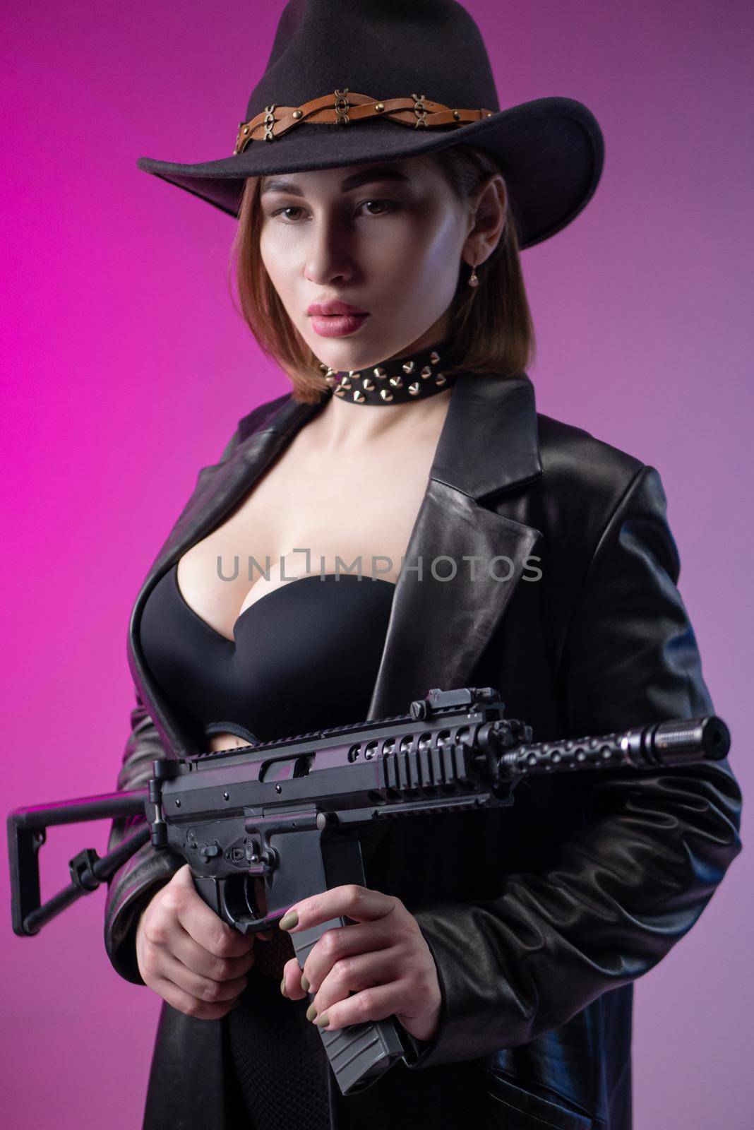 sexy woman with an automatic rifle in black leather clothes and hat by Rotozey