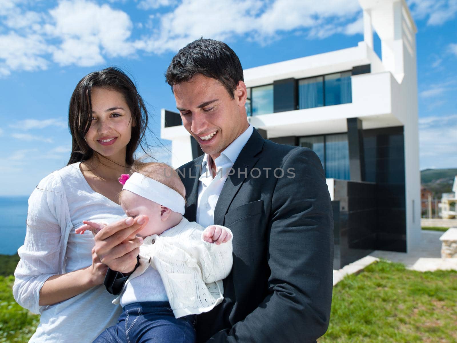 happy young family couple with beautiful new born baby have fun at modern  home