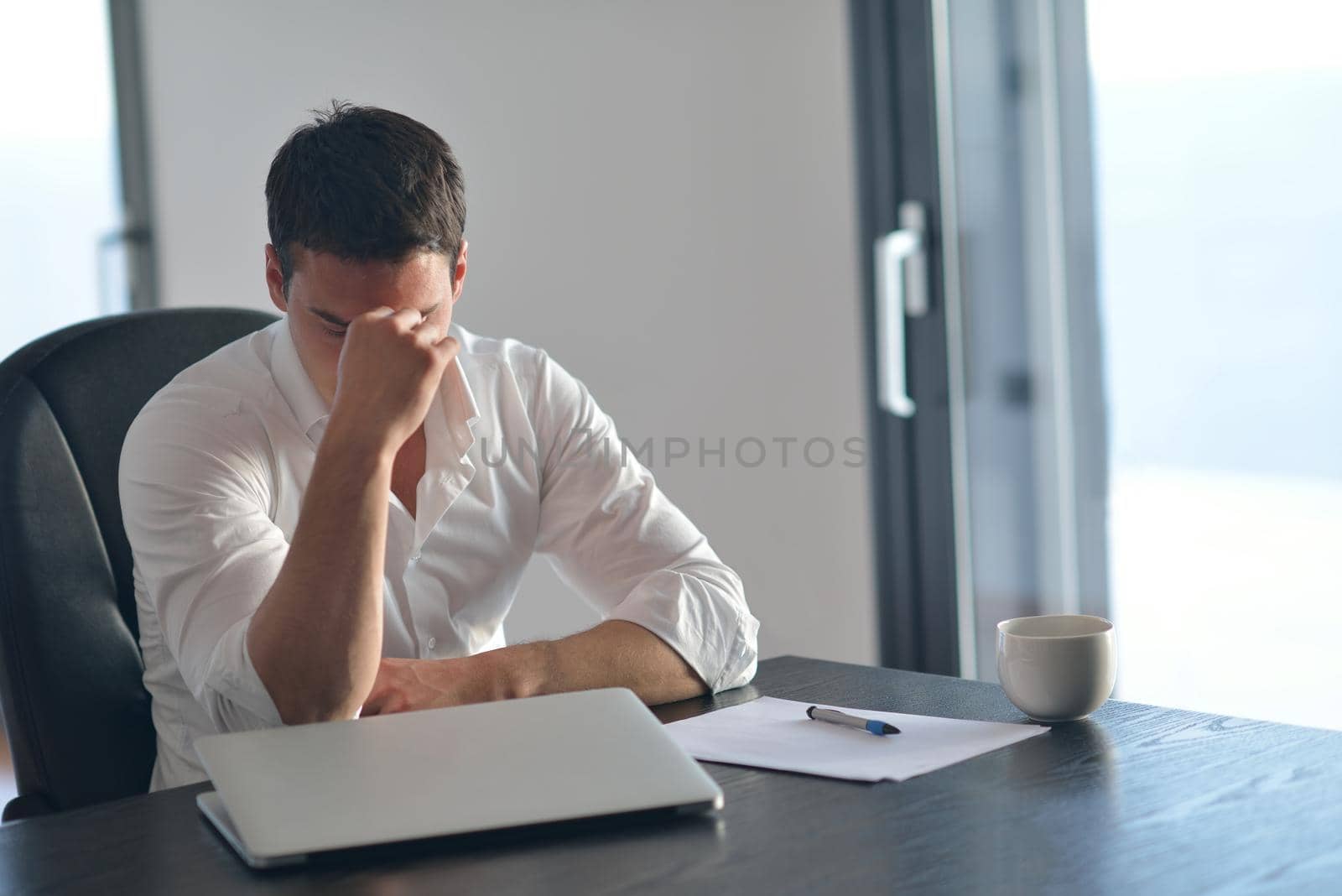 frustrated with problems young business man working on laptop computer at home