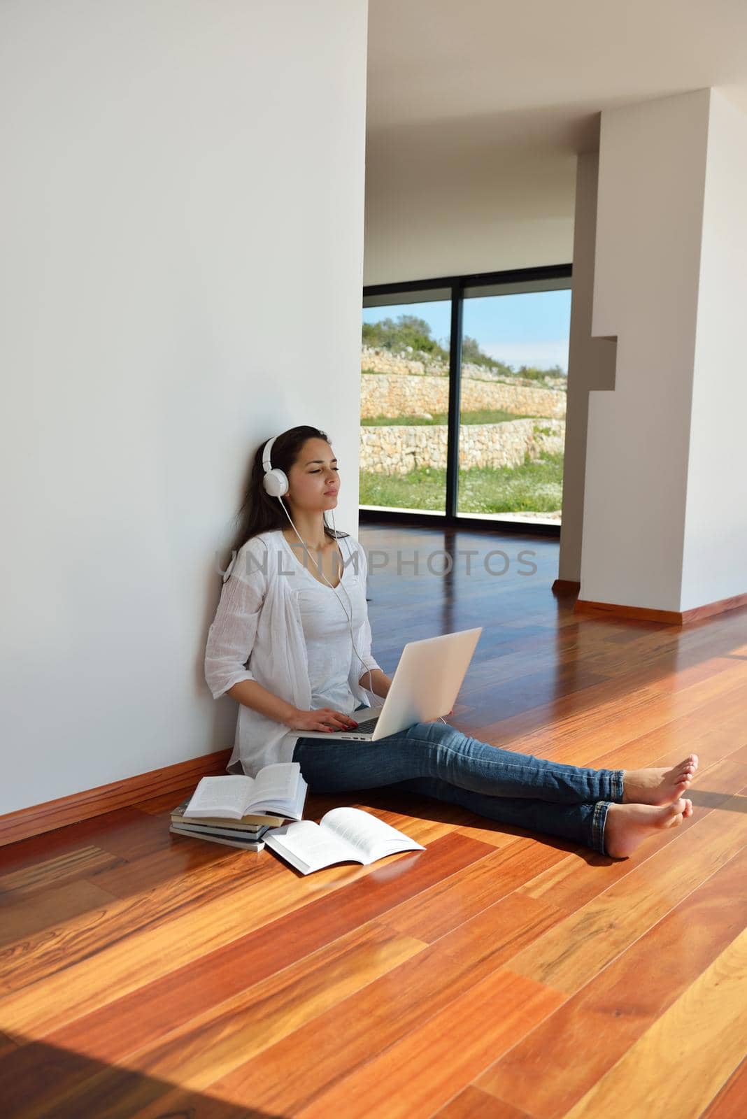 beautiful young woman relax and work on laptop computer while working on laptop computer and read book at home