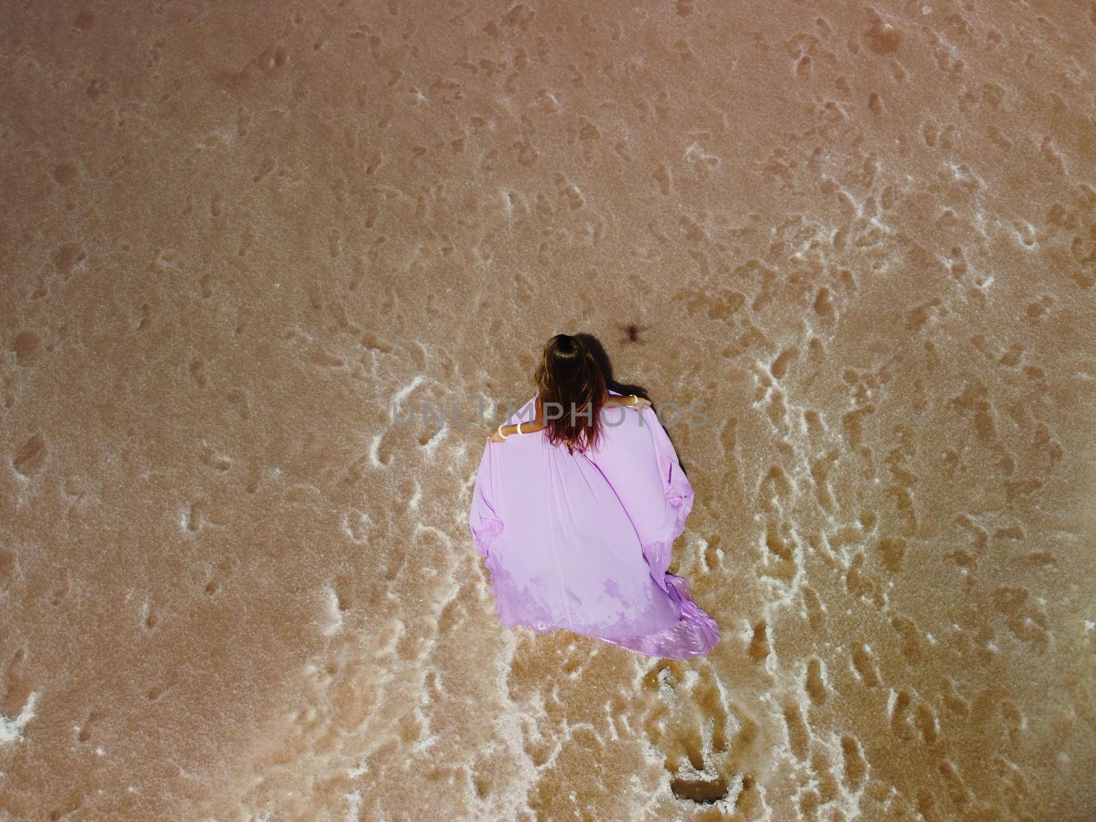 Aerial drone footage of a pink salt lake on a beautiful summer evening. Aerial view of a dried pink salt lake on a beautiful summer evening. Aerial view of a drying out salt lake.