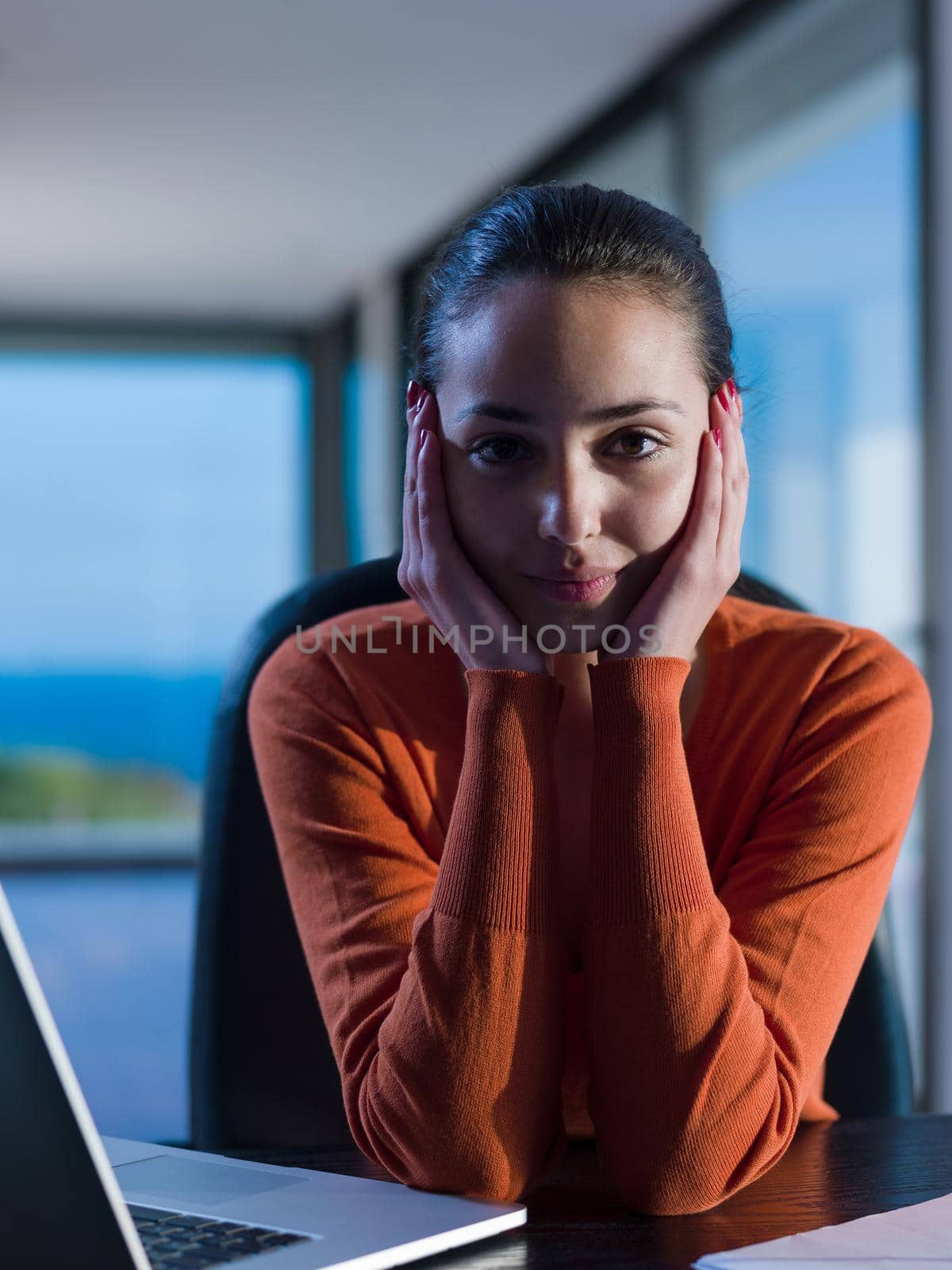 relaxed young woman at home working on laptop computer by dotshock