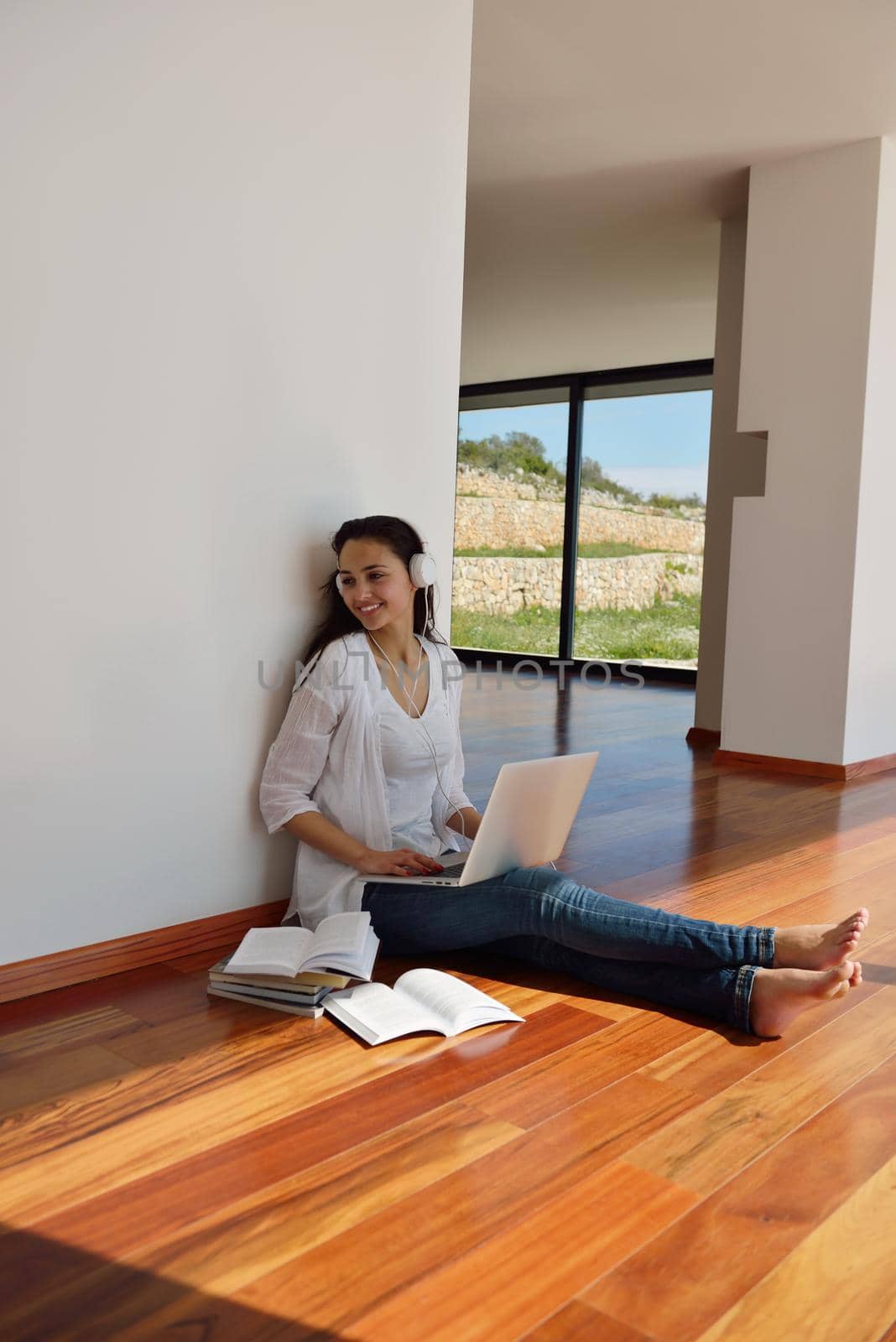 beautiful young woman relax and work on laptop computer while working on laptop computer and read book at home