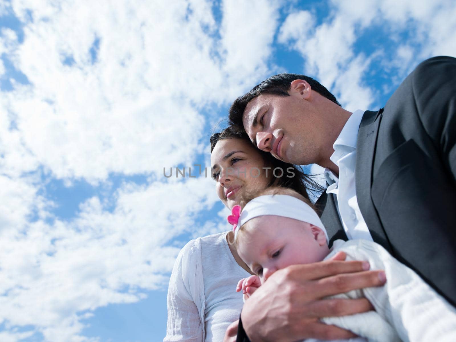 happy young family couple with beautiful new born baby have fun at modern  home