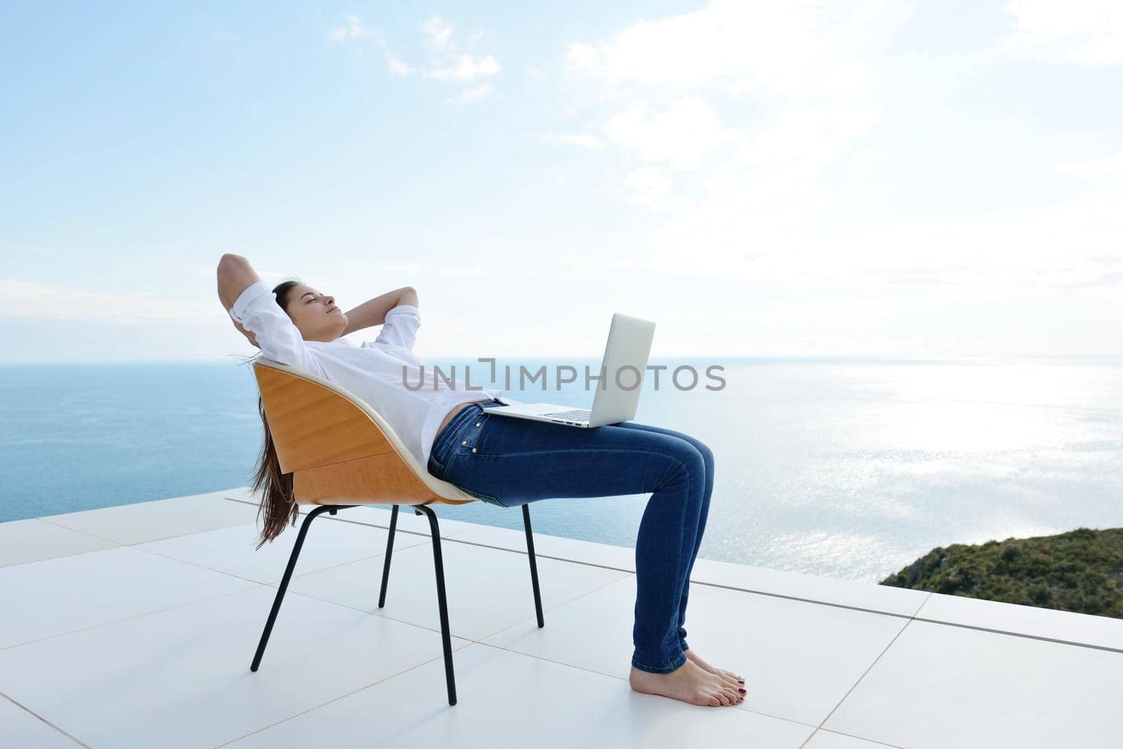 beautiful young woman relax and work on laptop computer while working on laptop computer and read book at home