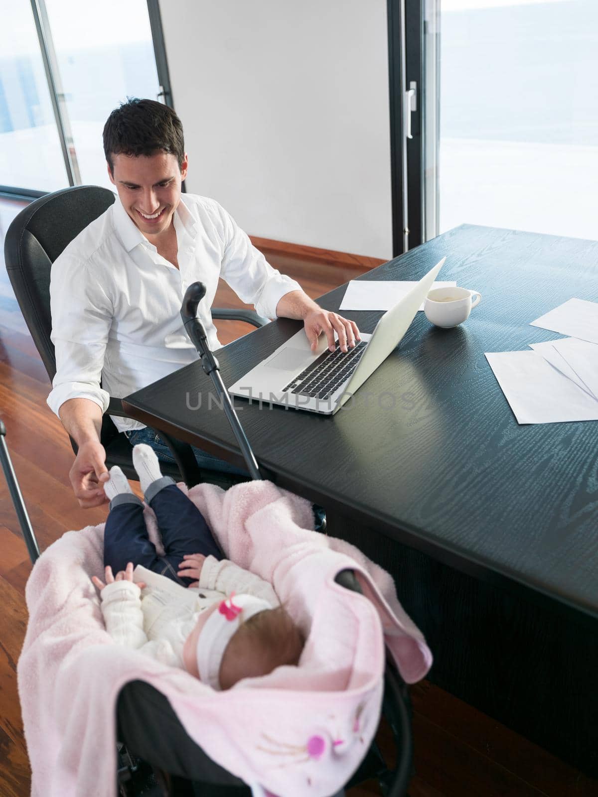 man working from home and take care of baby by dotshock