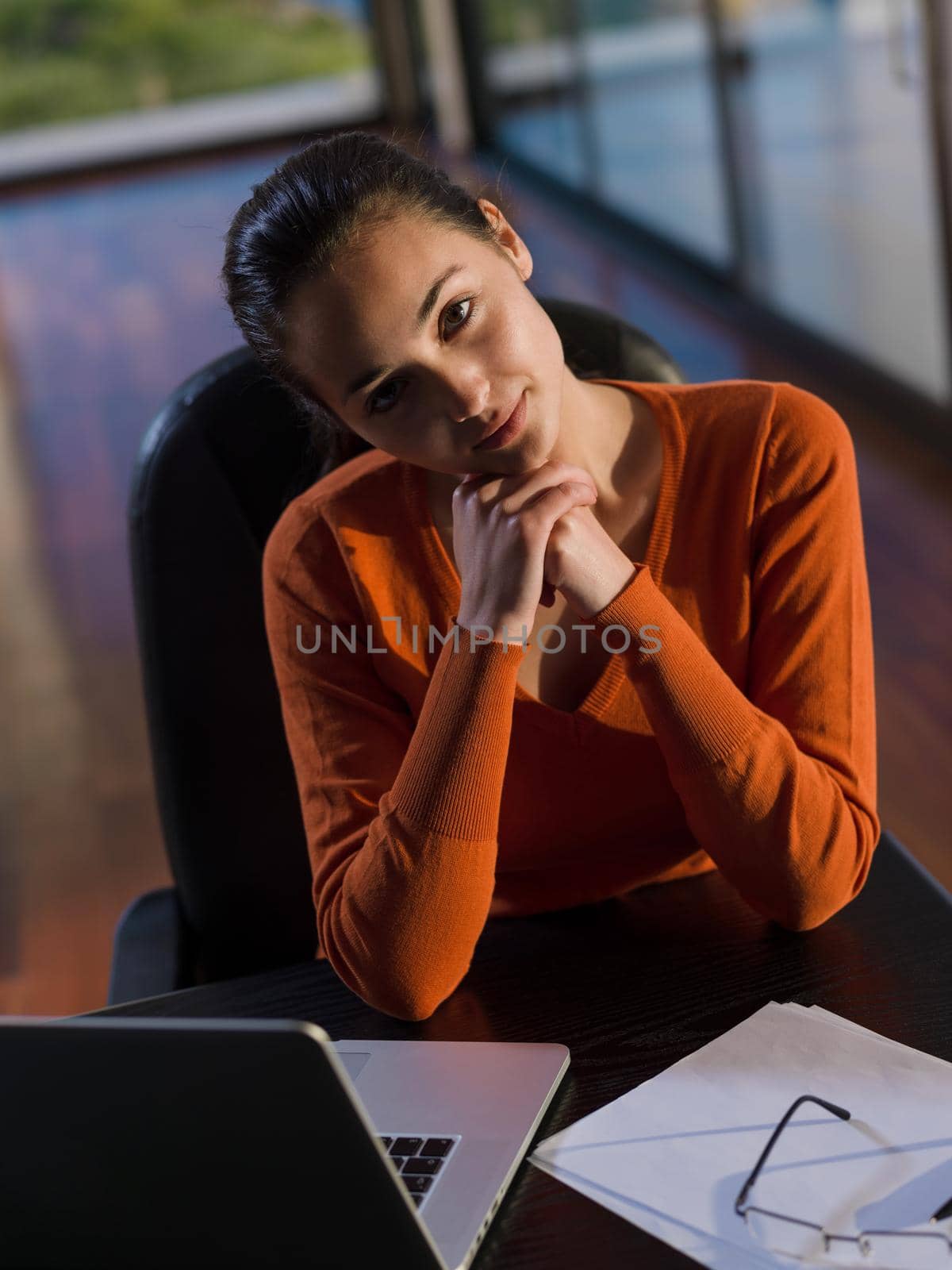 relaxed young woman at home working on laptop computer by dotshock