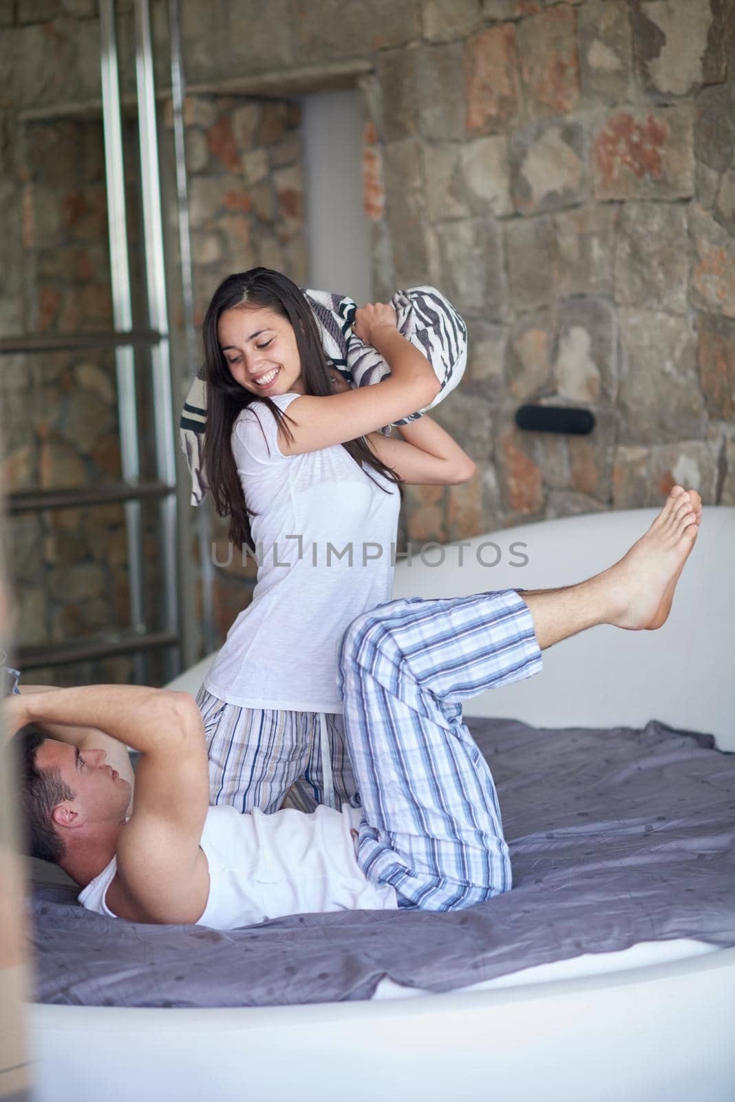 happy young couple relax and have fun in bed