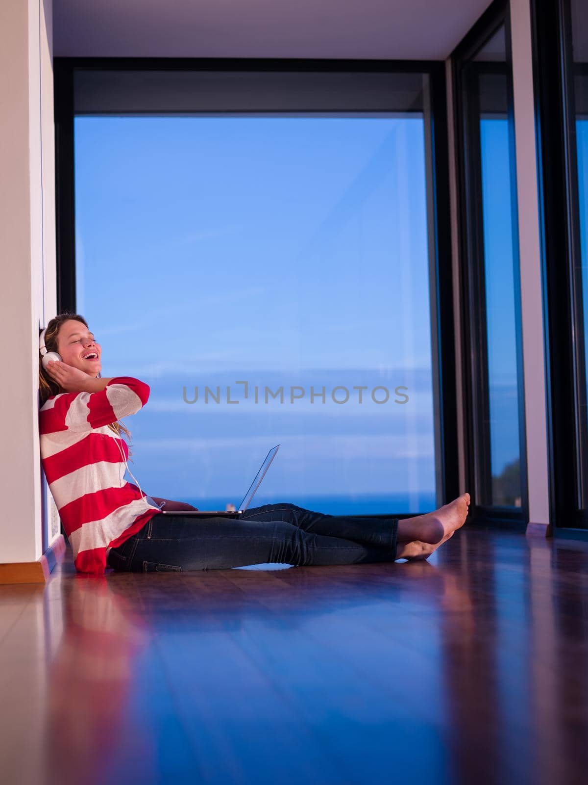 beautiful young woman relax and work on laptop computer while working on laptop computer and read book at home