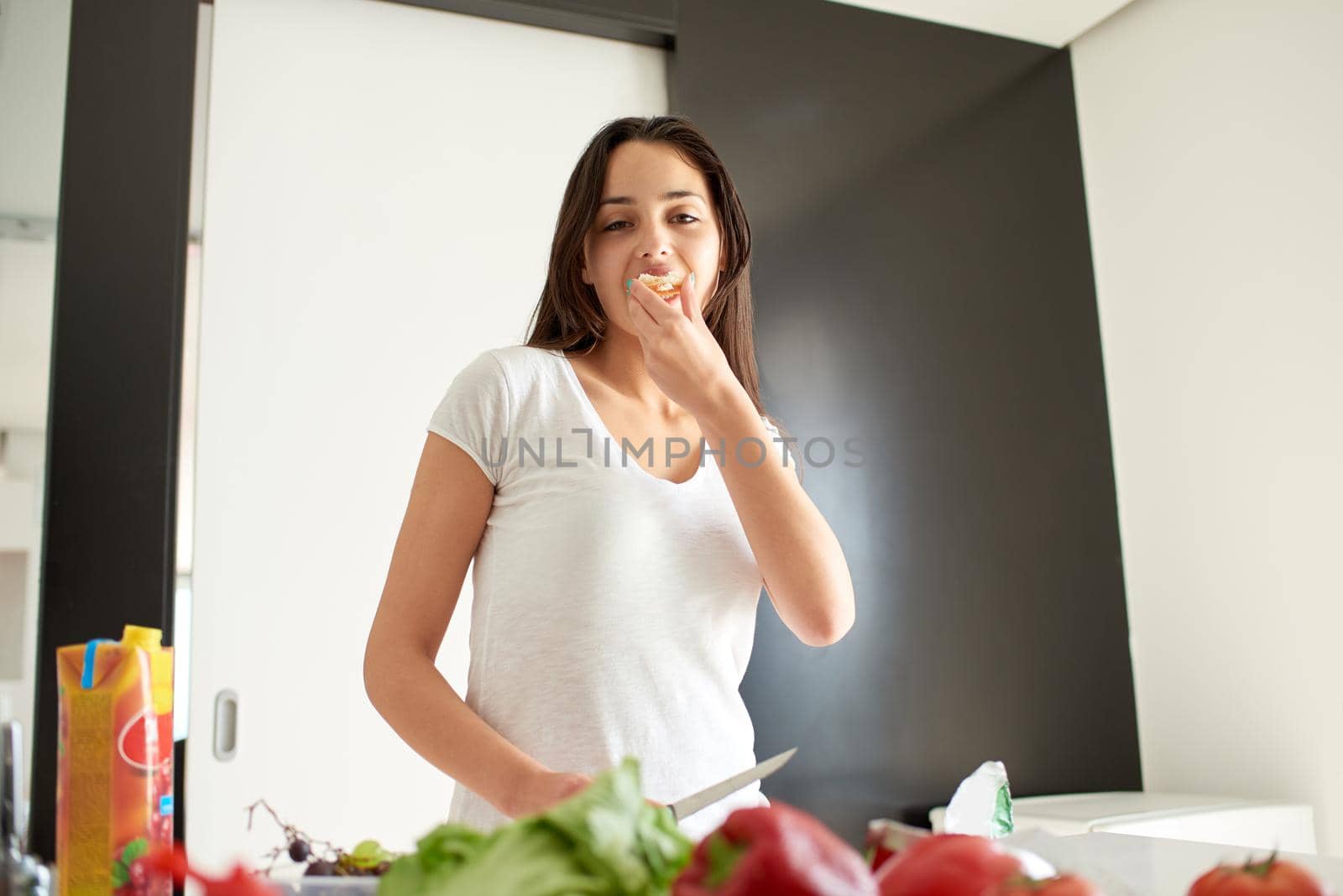 Young Woman Cooking in the kitchen. Healthy Food - Vegetable Salad. Diet. Dieting Concept. Healthy Lifestyle. Cooking At Home. Prepare Food