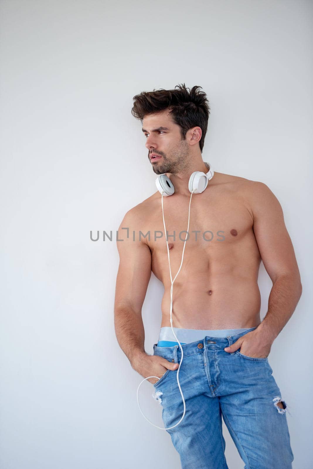 handsome young man listening music on headphones by dotshock