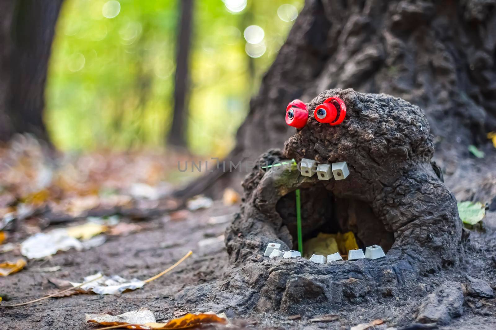 Forest stump in the form of a goblin. Nature screams about help. Close-up