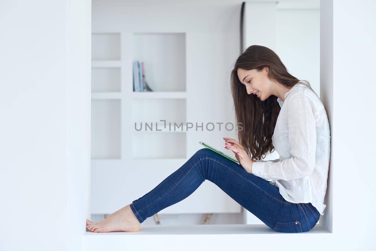 woman at home using tablet by dotshock