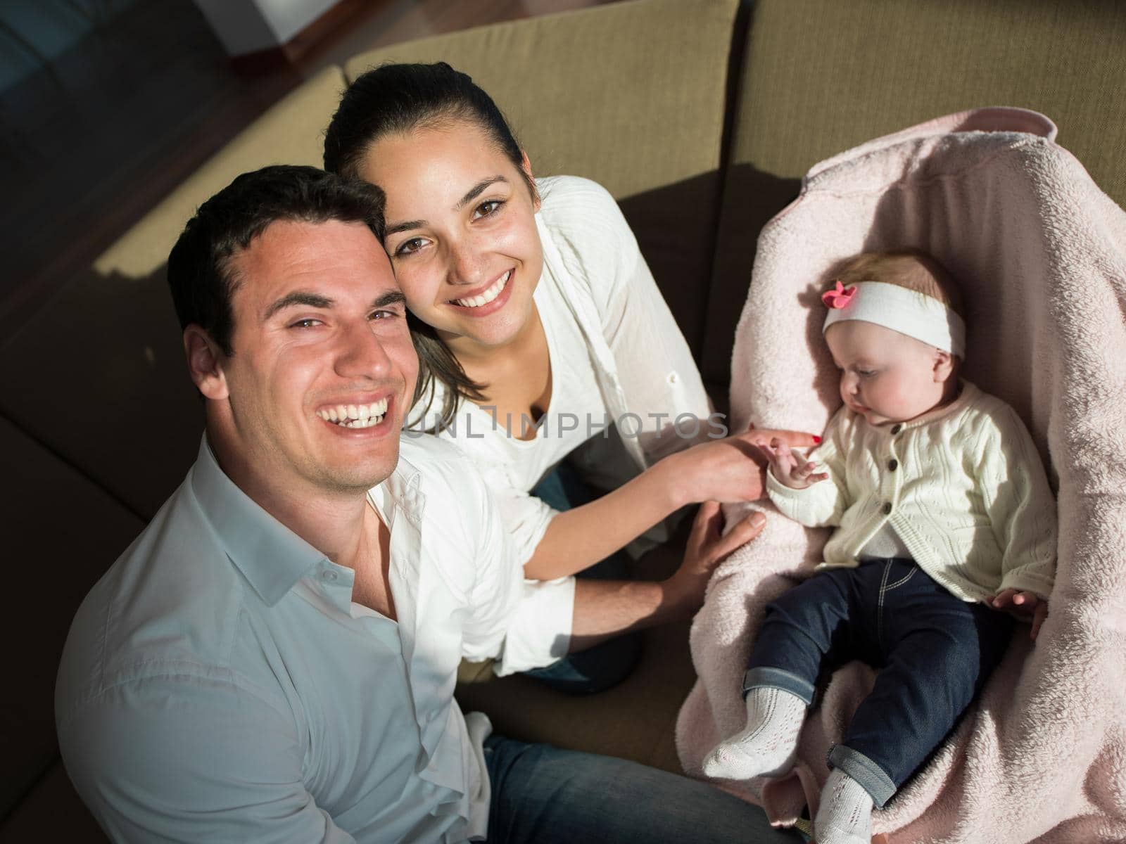 happy young family couple with beautiful new born baby have fun at modern  home