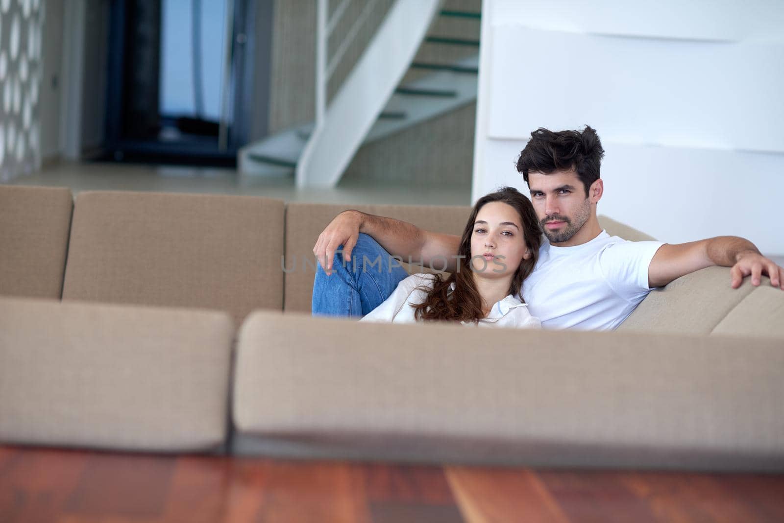 romantic happy young couple relax at modern home staircase indoors