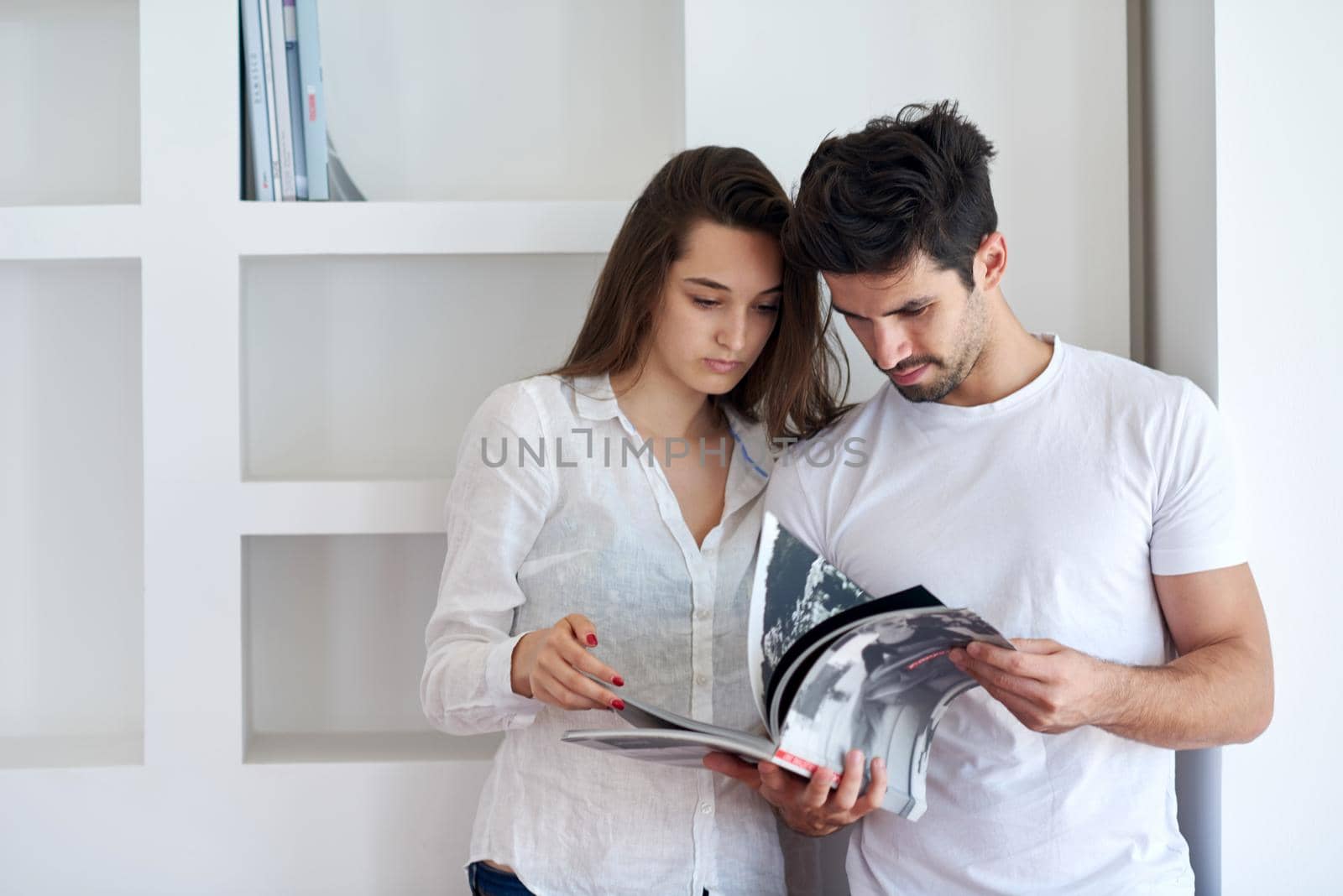 romantic happy young couple relax at modern home staircase indoors