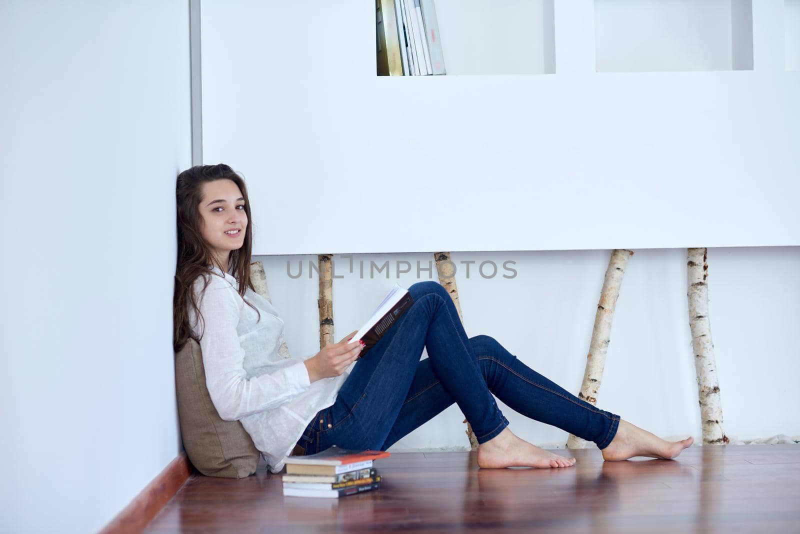 beautiful young woman relax and work on laptop computer modern  home office while listening musin on white headphones