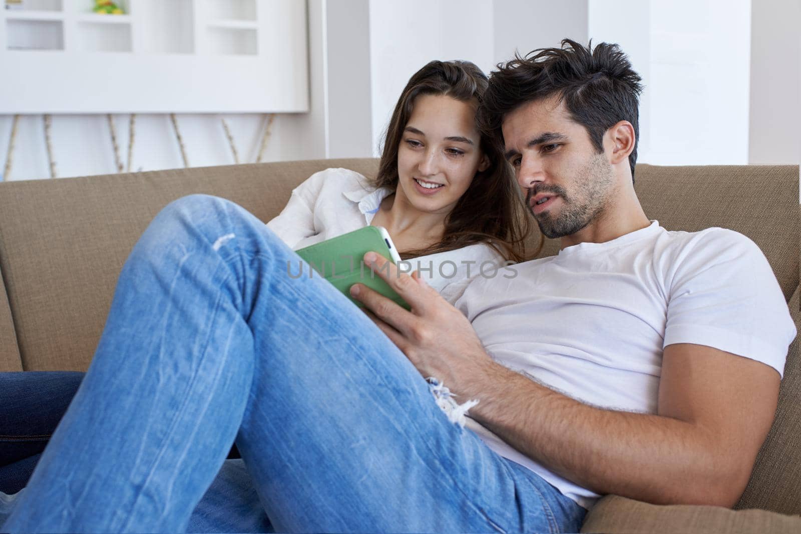 romantic relaxed young couple at modern home using tablet computer