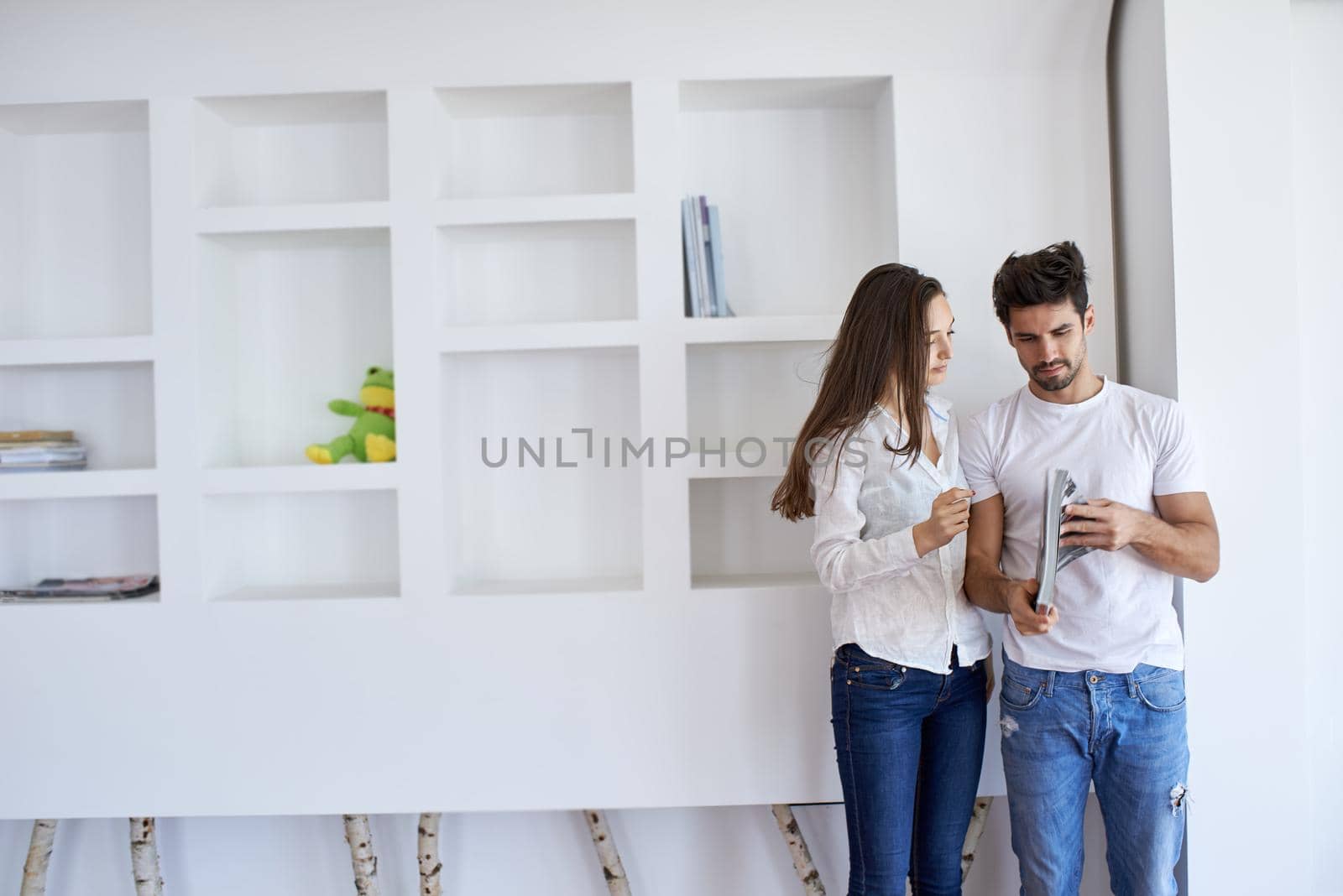 romantic happy young couple relax at modern home staircase indoors