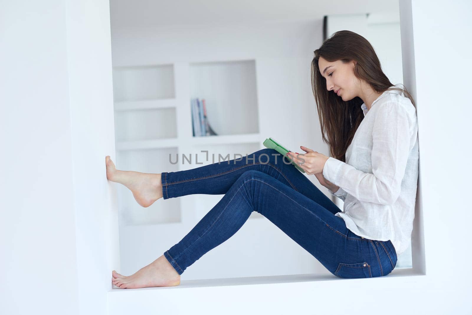 woman at home using tablet by dotshock