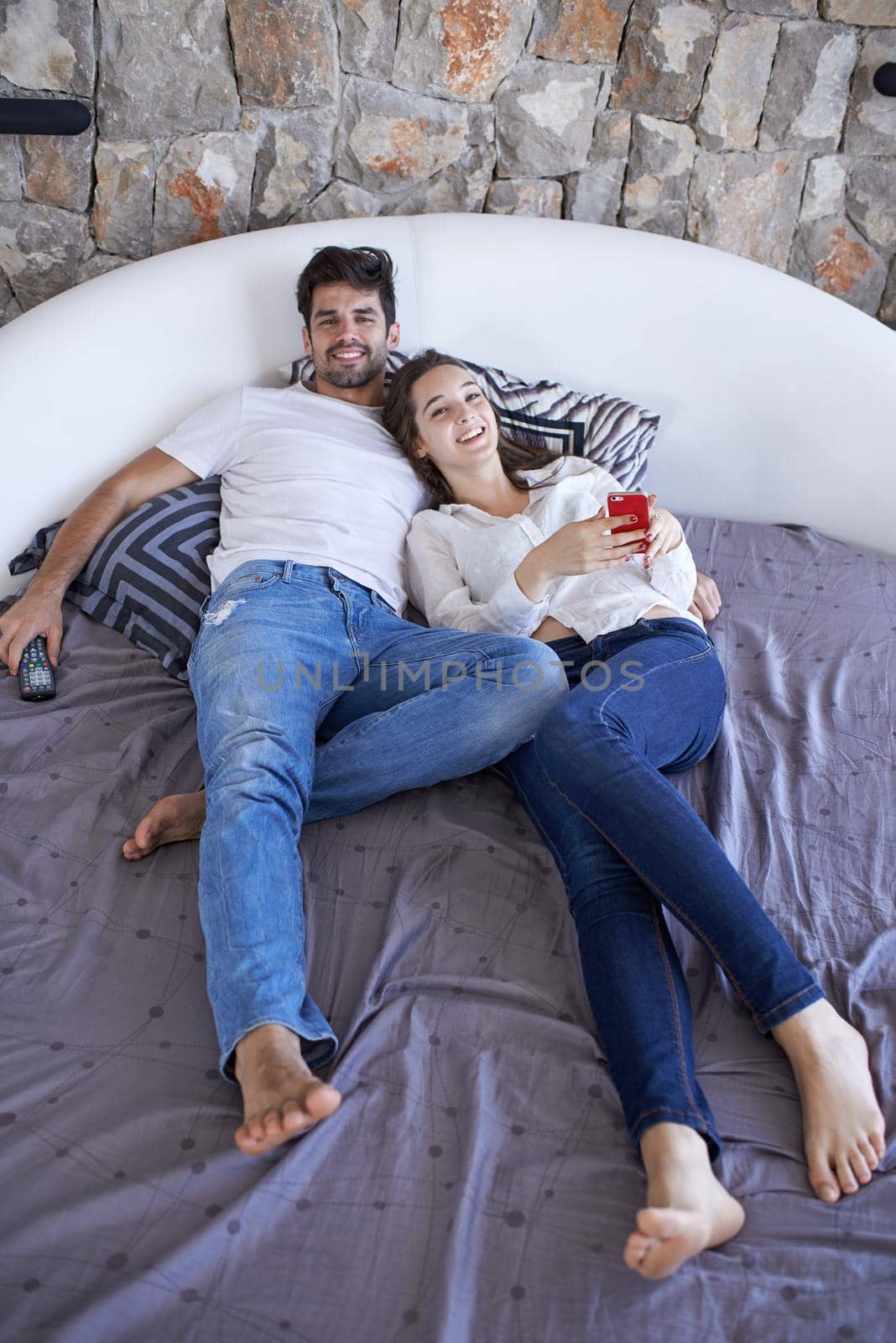 happy young couple relax and have fun in bed